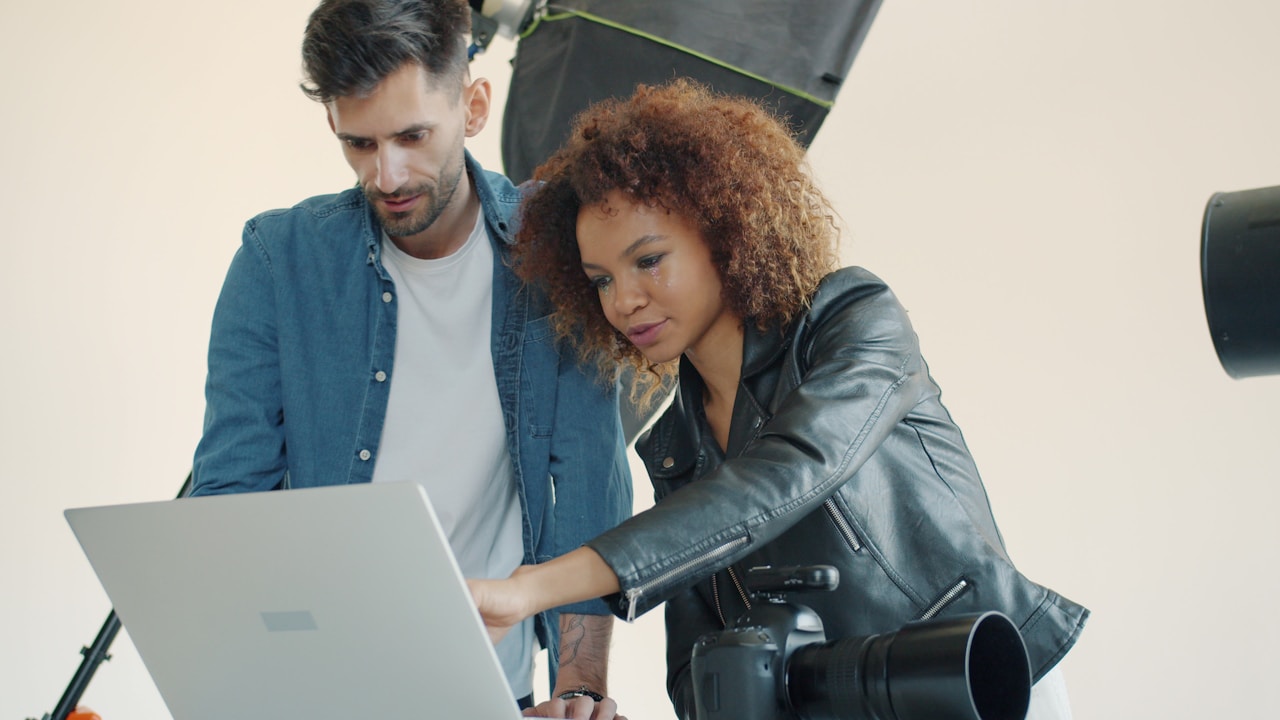 People reviewing creative variants on a laptop screen