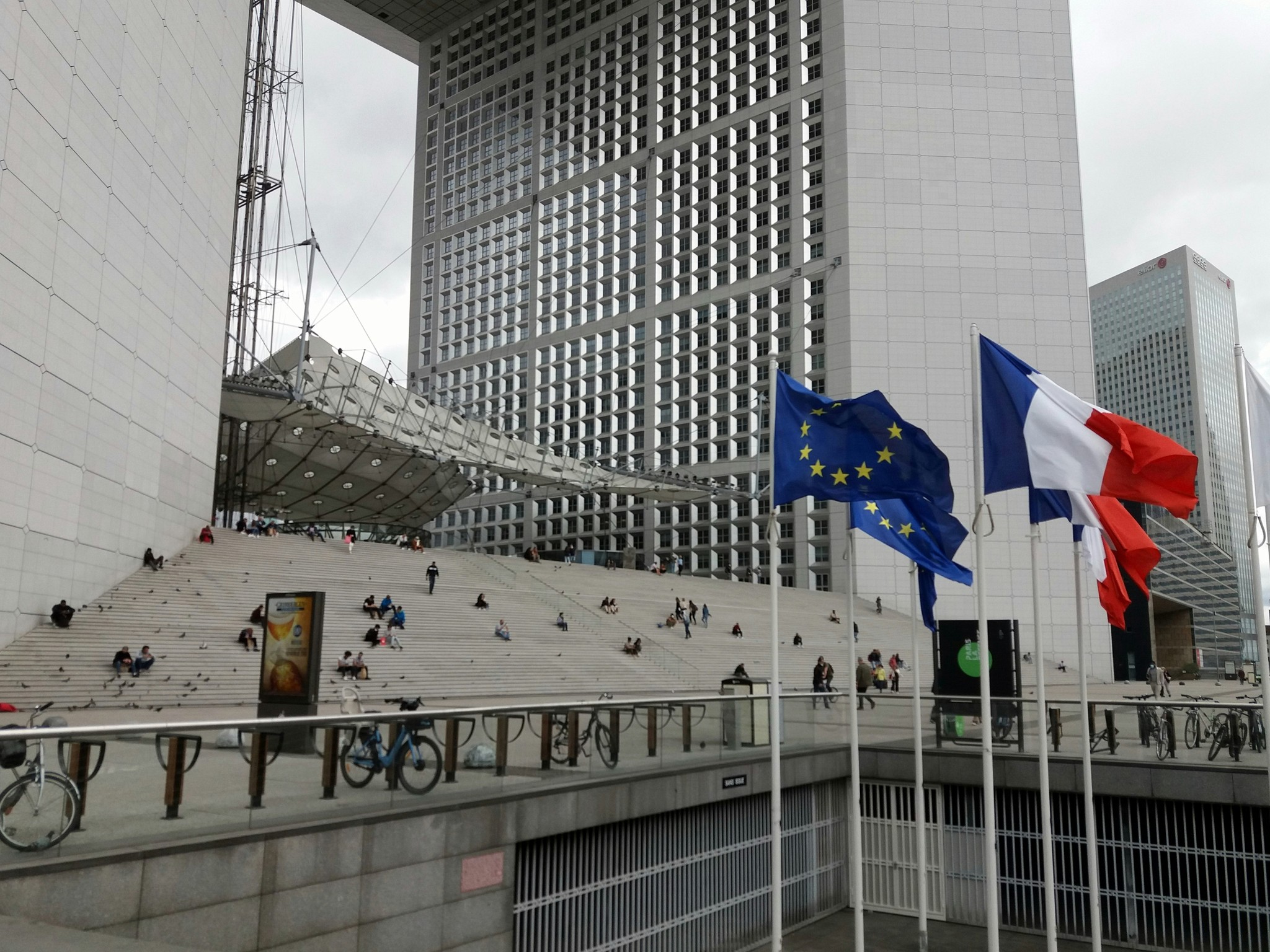 a group of flags flying in front of a building