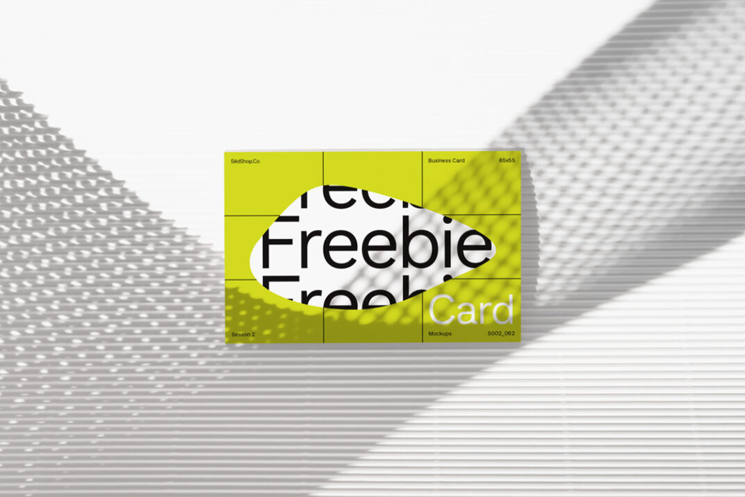 Business card mockup featuring a vibrant lime-green card with a central cutout revealing bold black text on a white background. Displayed against a patterned shadow backdrop for a modern, textured aesthetic.