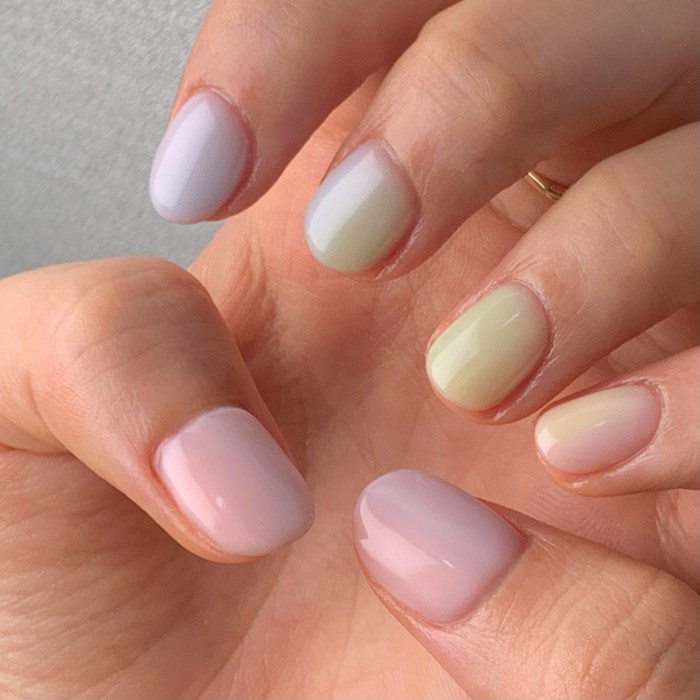 Short rounded nails in lilac, lemon and mint pastel gel