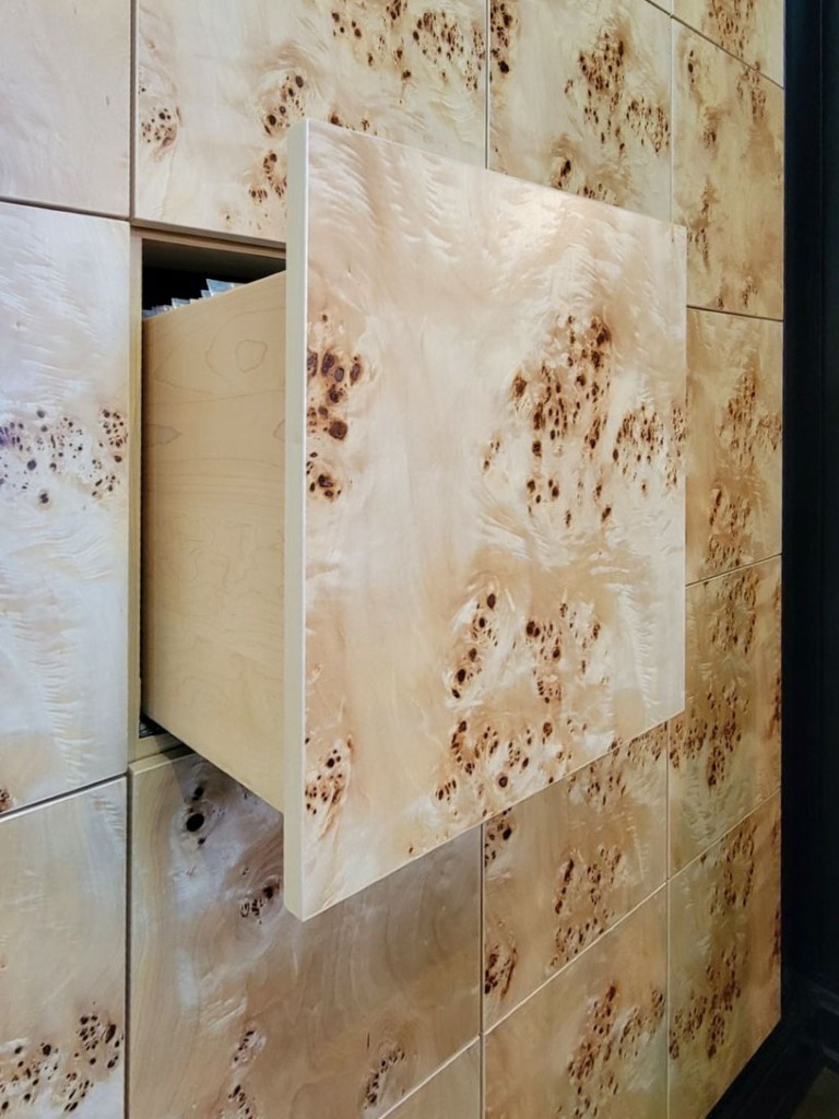 Image of KHD Homes design-build interior featuring birch wood paneling and custom cabinetry with furniture like drawers.