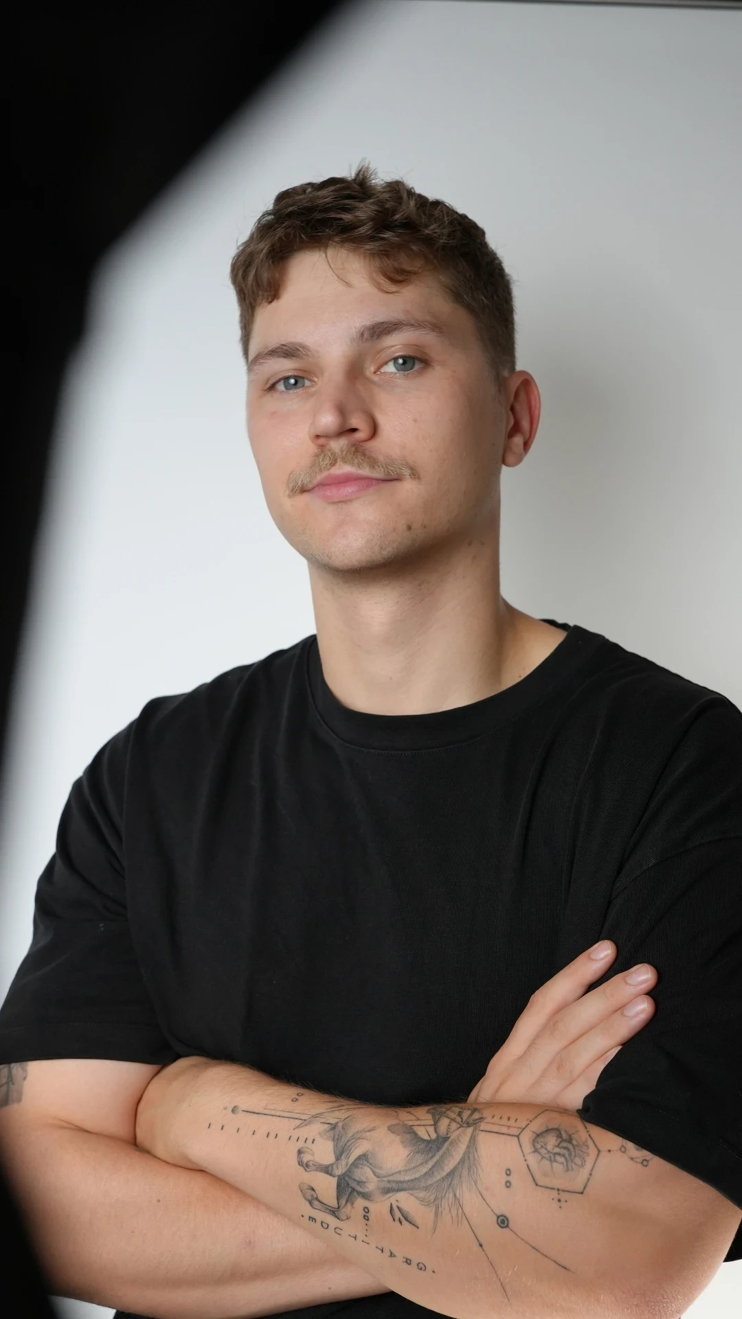 Creator filming with a camera on a tripod indoors