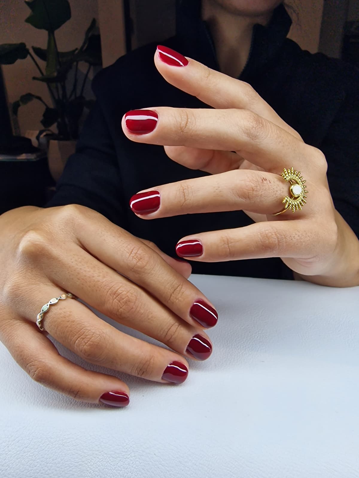 Woman with pastel rainbow nails and bold pink eyeshadow