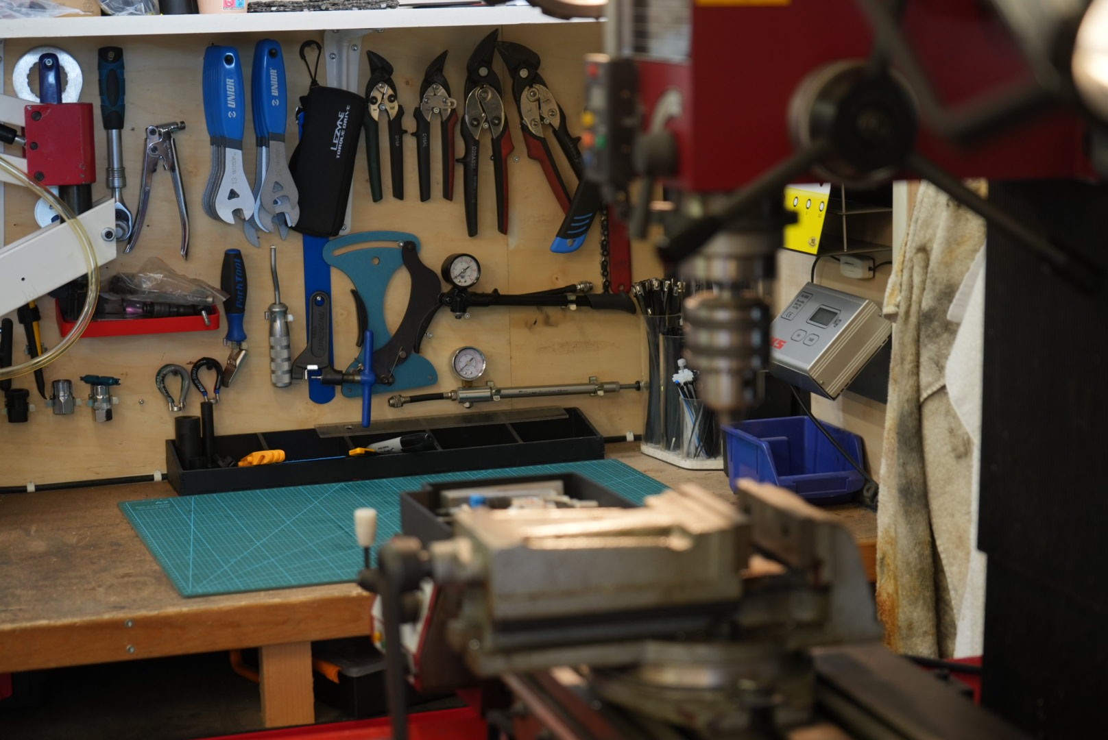 Modern brick and glass building reflecting the blue sky, with pedestrians and cyclists moving through a sunlit urban plaza, creating dynamic motion blur effects.