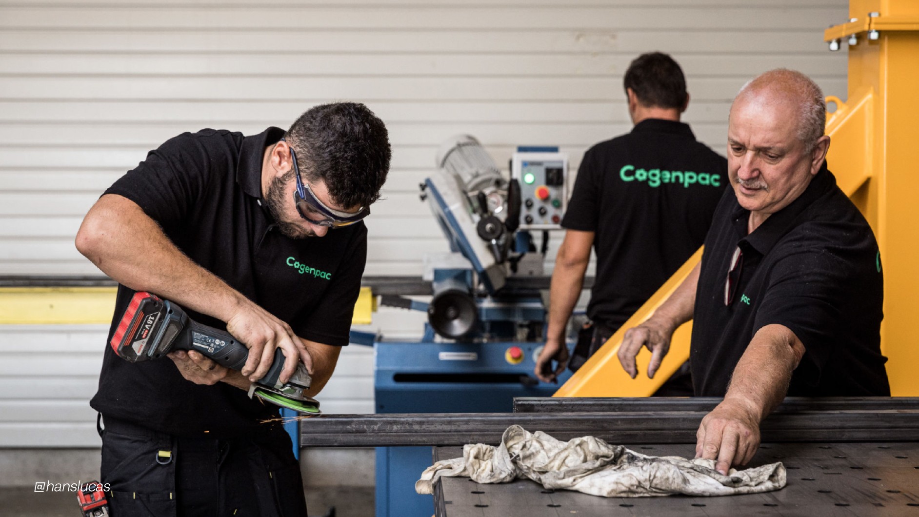 Modern home office setup with a monitor, ergonomic chair, keyboard, and indoor plants near a window with blinds.
