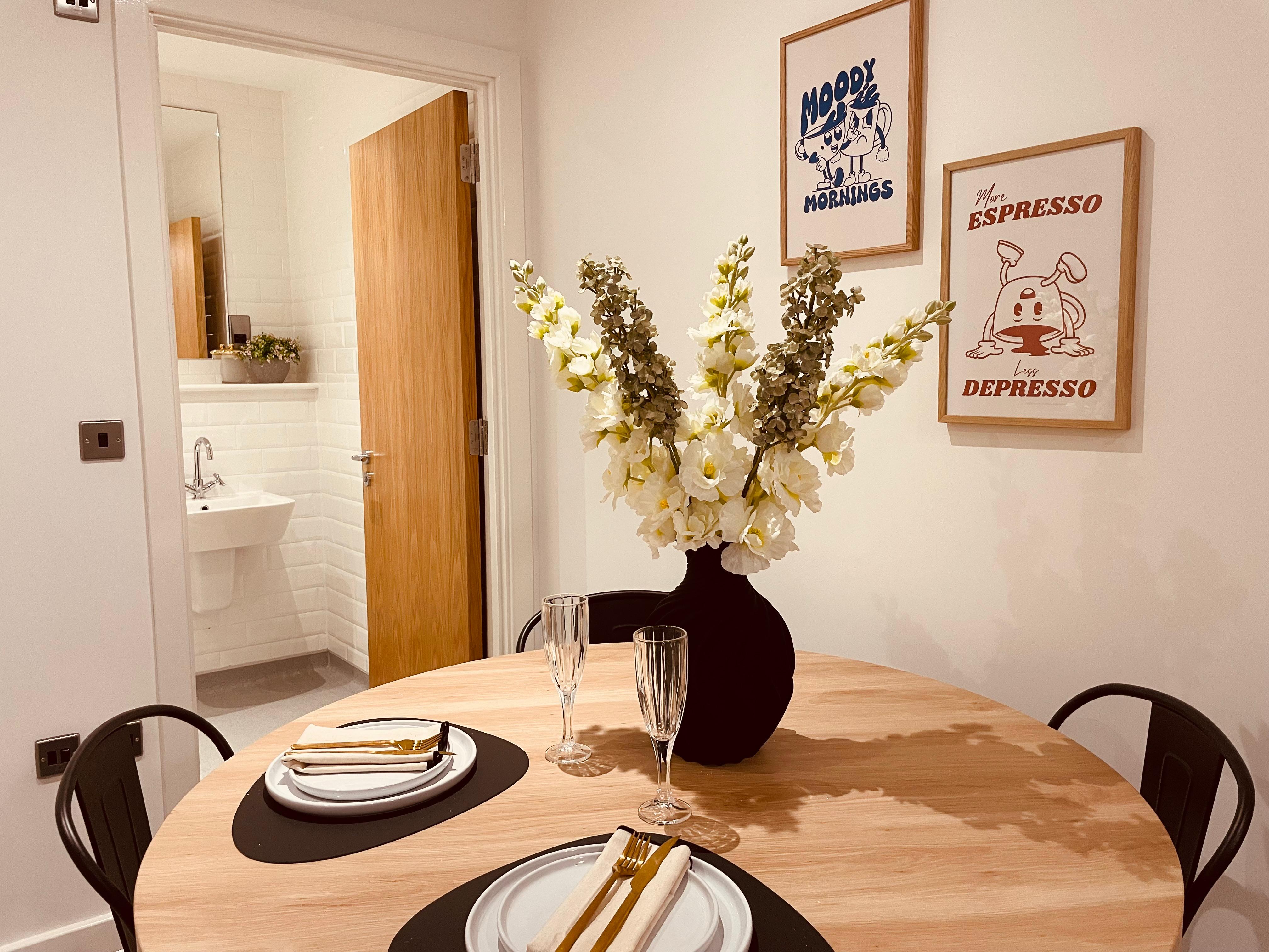 Dining table and artwork in show home design in Manchester