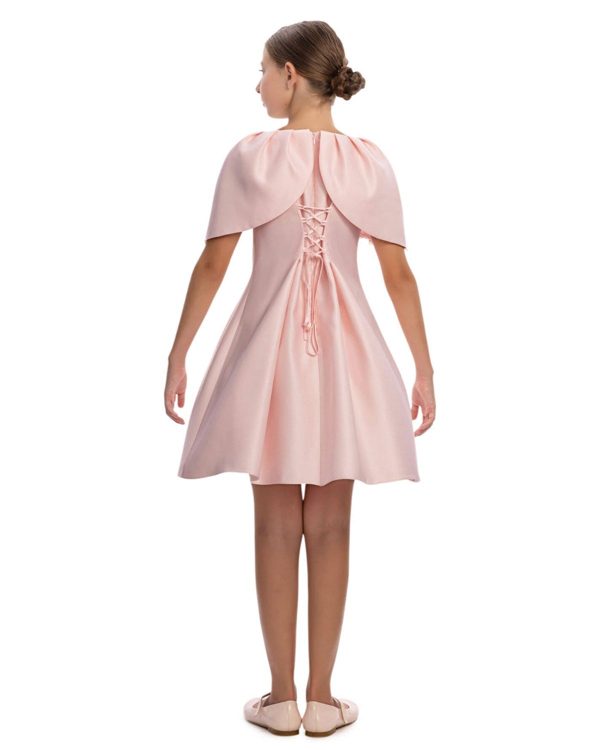 Pink dress with capelet worn by a model on a white background