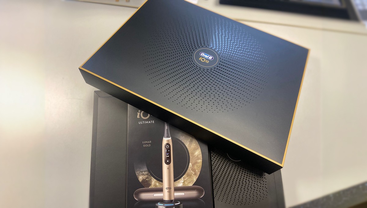 Family standing in a lush green field with tractor.