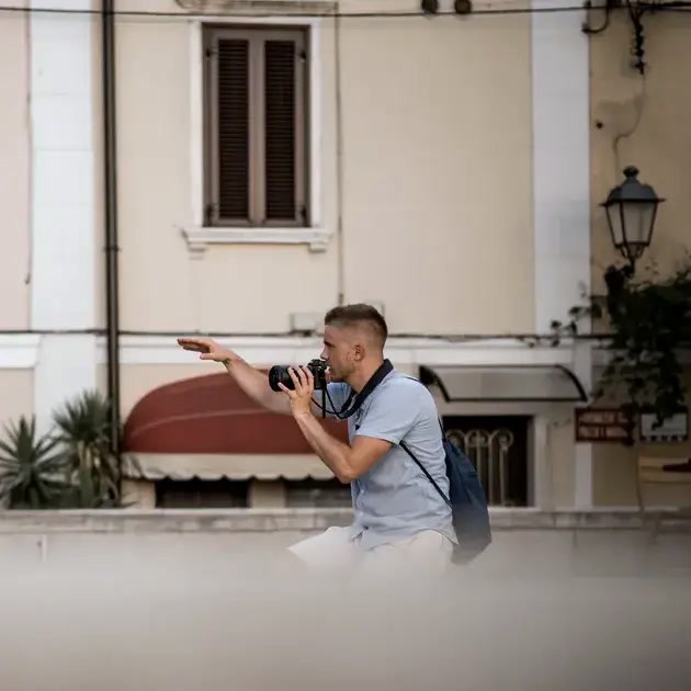 Minimalist brushed-steel chair in a white corner studio—industrial, brutalist modern furniture.