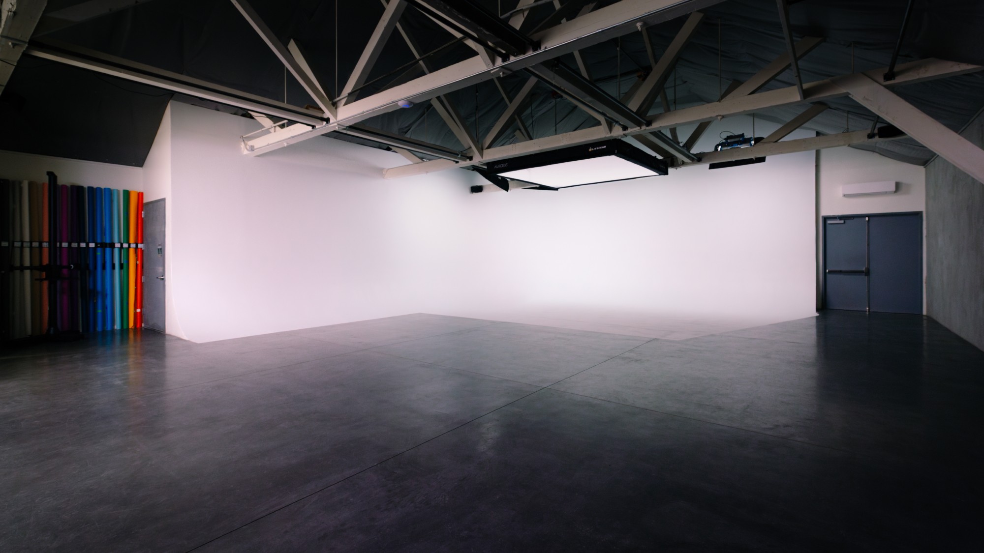 Founder Matt Lowe walks across the soundproof studio floor at Particle Studios in Seattle. A Digital Sputnik DS-6 shines into the distance.