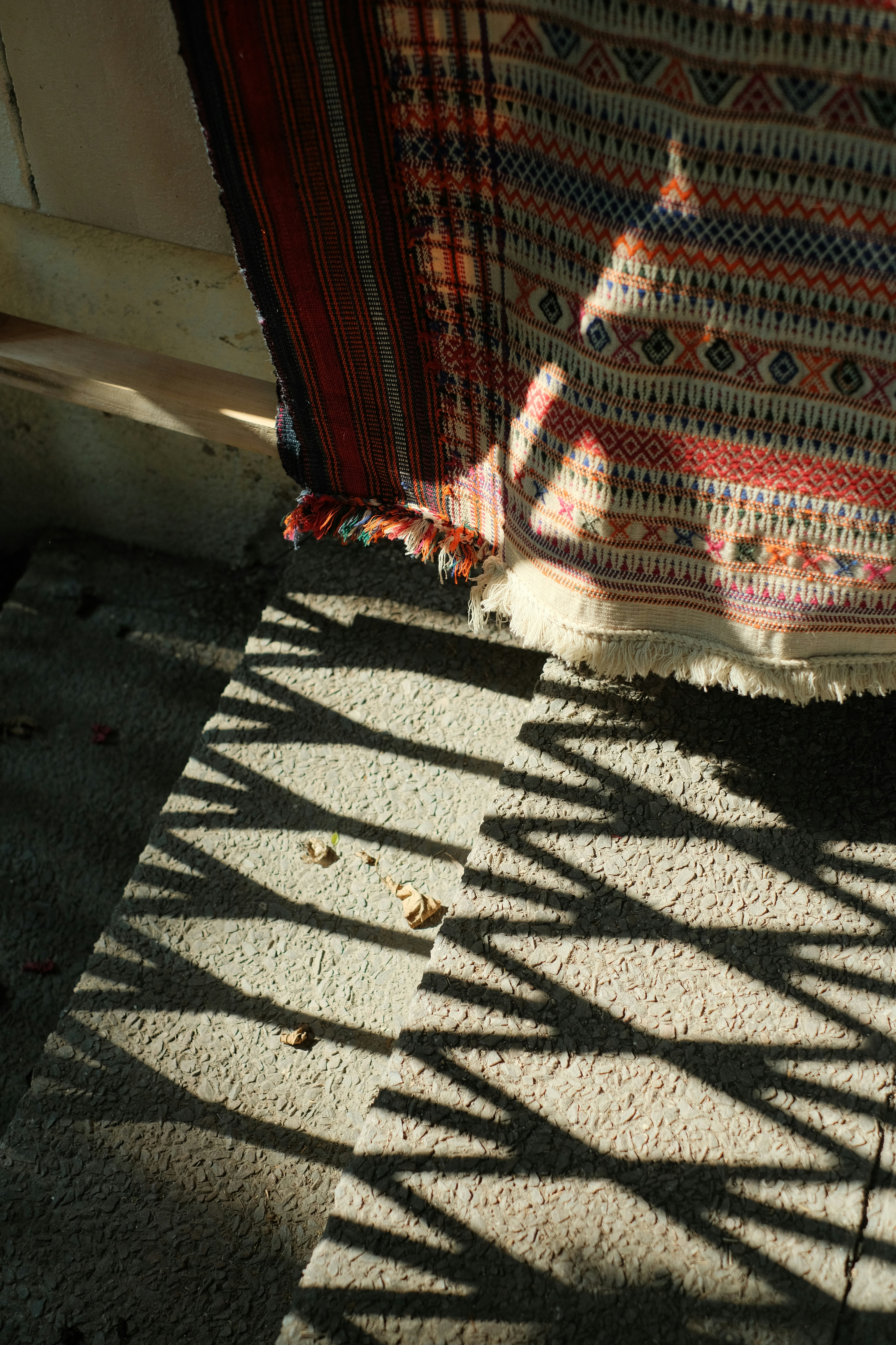 the shadow of a blanket on the ground