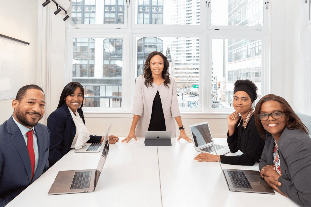 People having a meeting at an office table in sunlight.