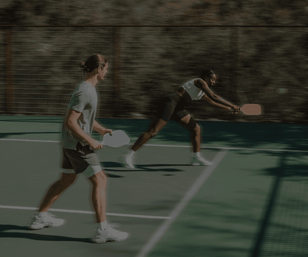 Padel academy website landing page showcasing players in action on a professional outdoor padel court.