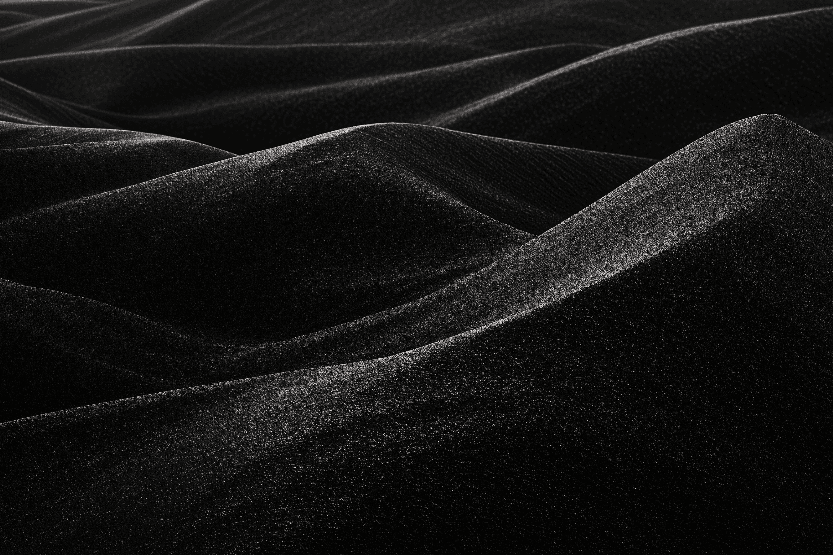 a black and white photo of water and sand