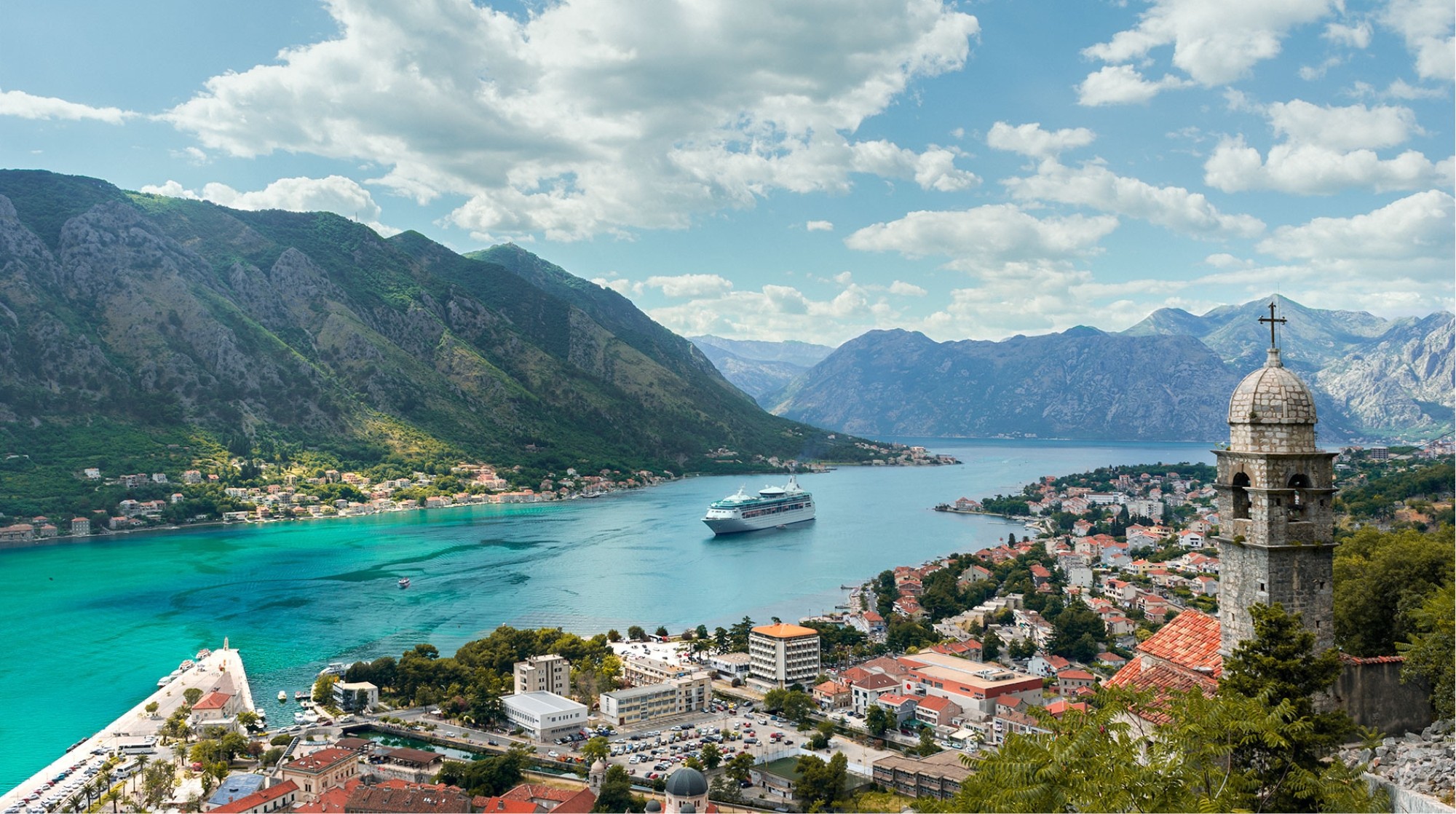 a river running through a lush green hillside