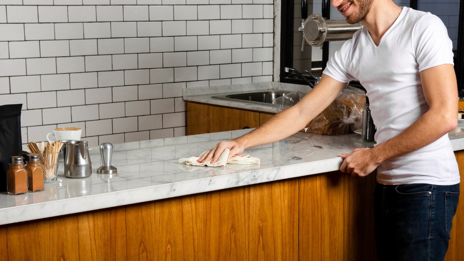 A person cleaning a marble countertop