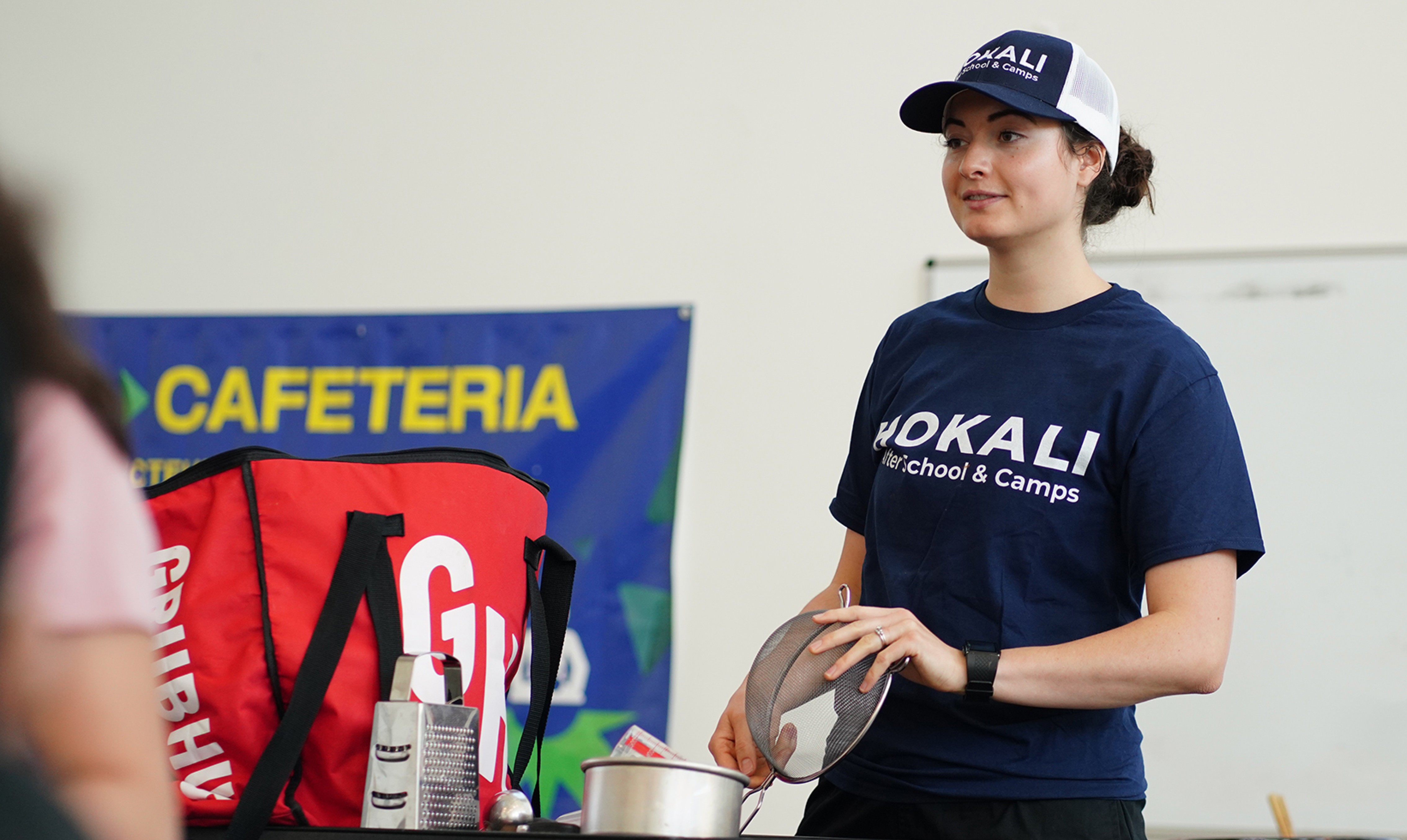 HOKALI educator leading an engaging classroom activity with elementary students during an enrichment program