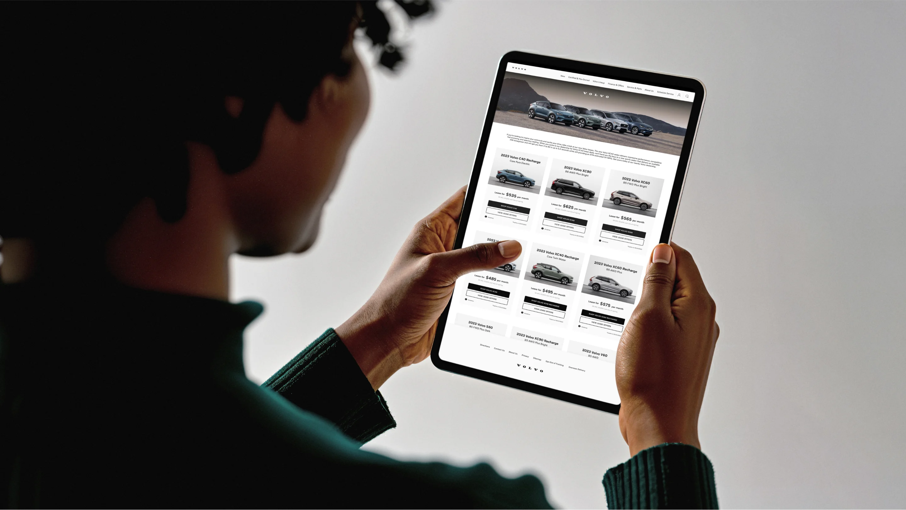 Volvo — Photo of person holding iPad with Volvo webpage design — UI/UX application
