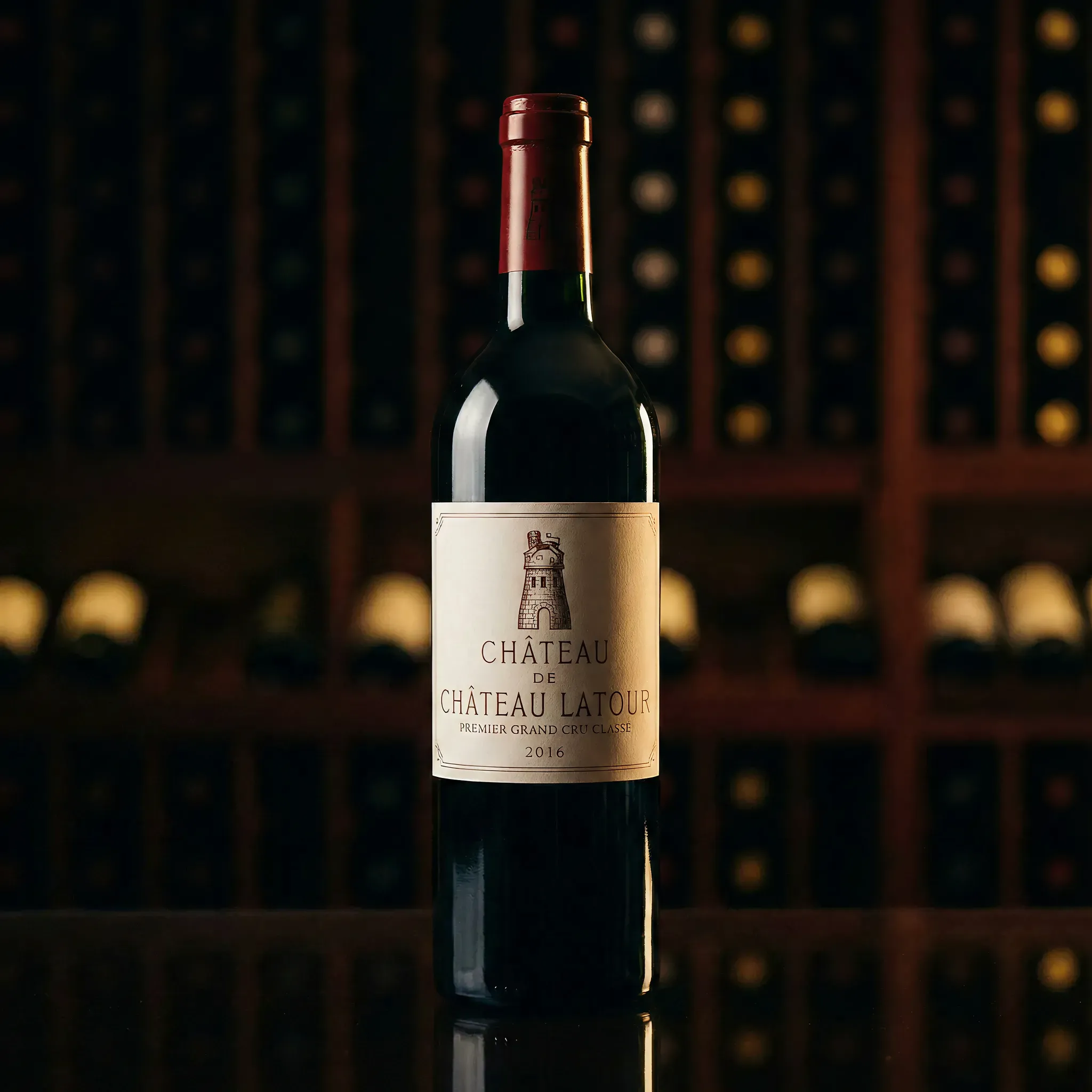 A bottle of Château Latour 2016 wine stands on a reflective surface. It's centered against a blurred wine rack, conveying elegance and sophistication.