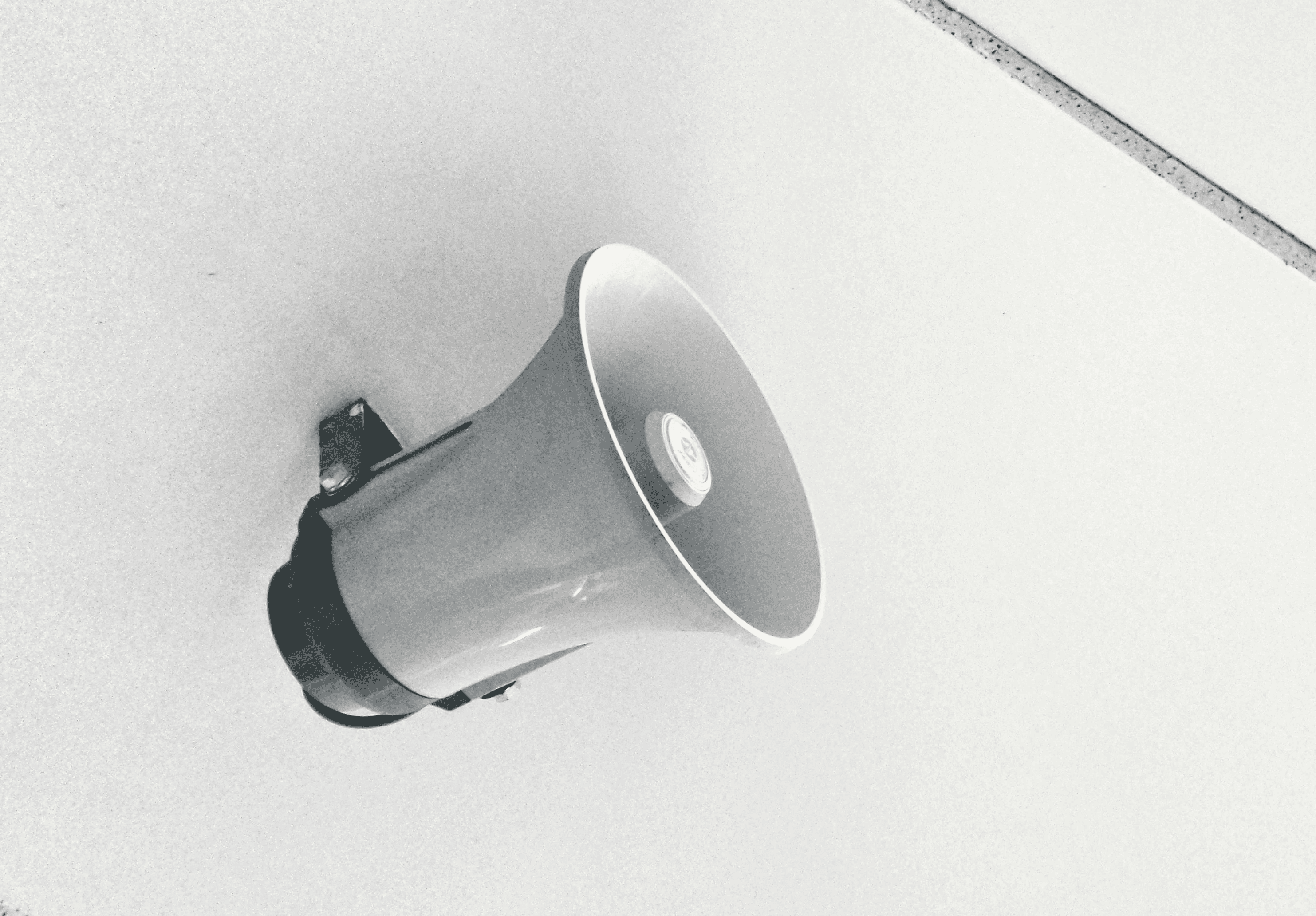 gray megaphone on white surface