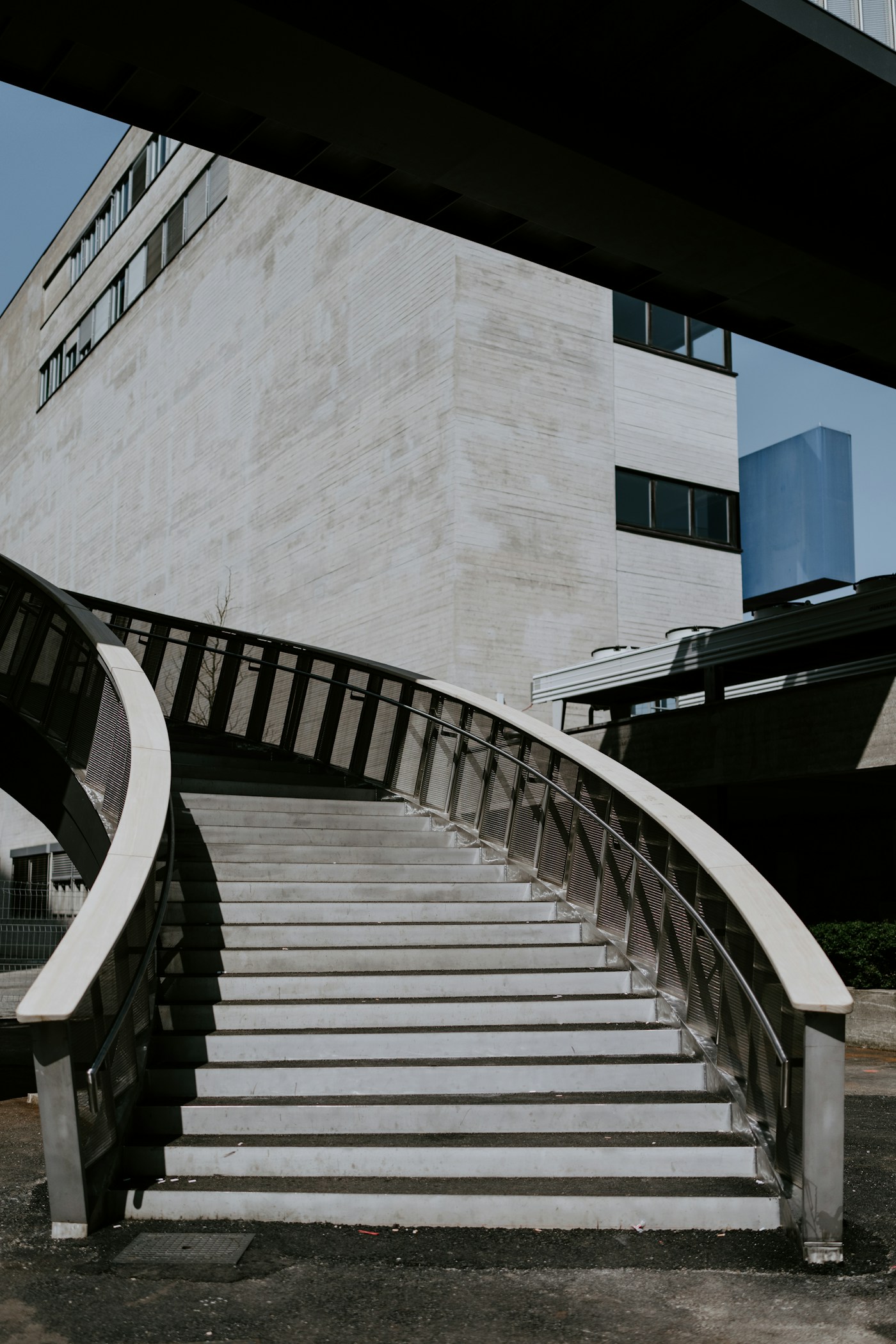 Sweeping curved staircase in a stone courtyard