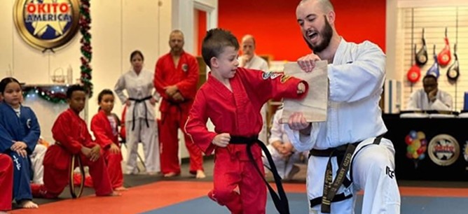 A martial arts student attempting a backhand board break.