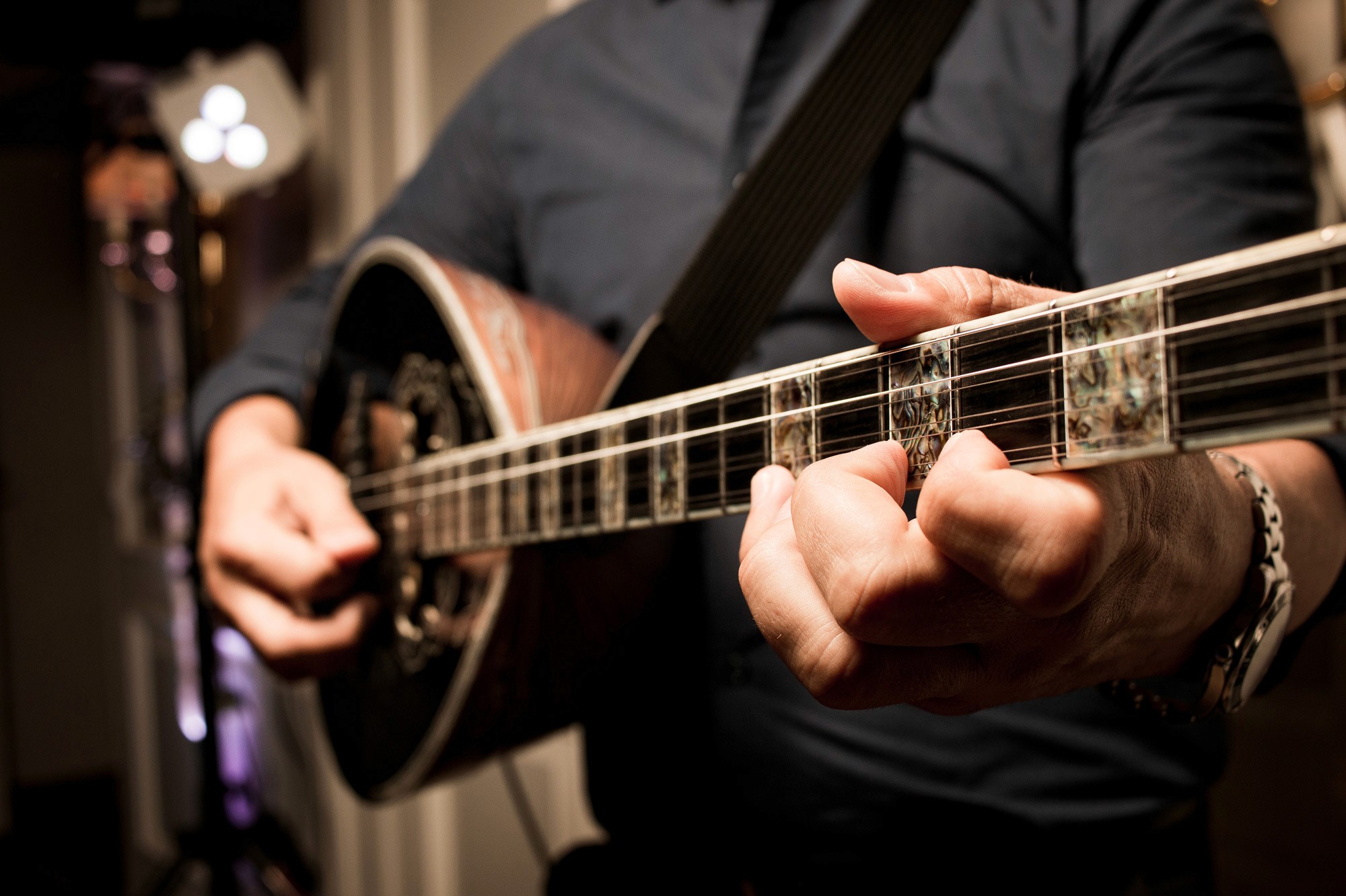 Close up of a musician playing Greek music on a Bouzouki