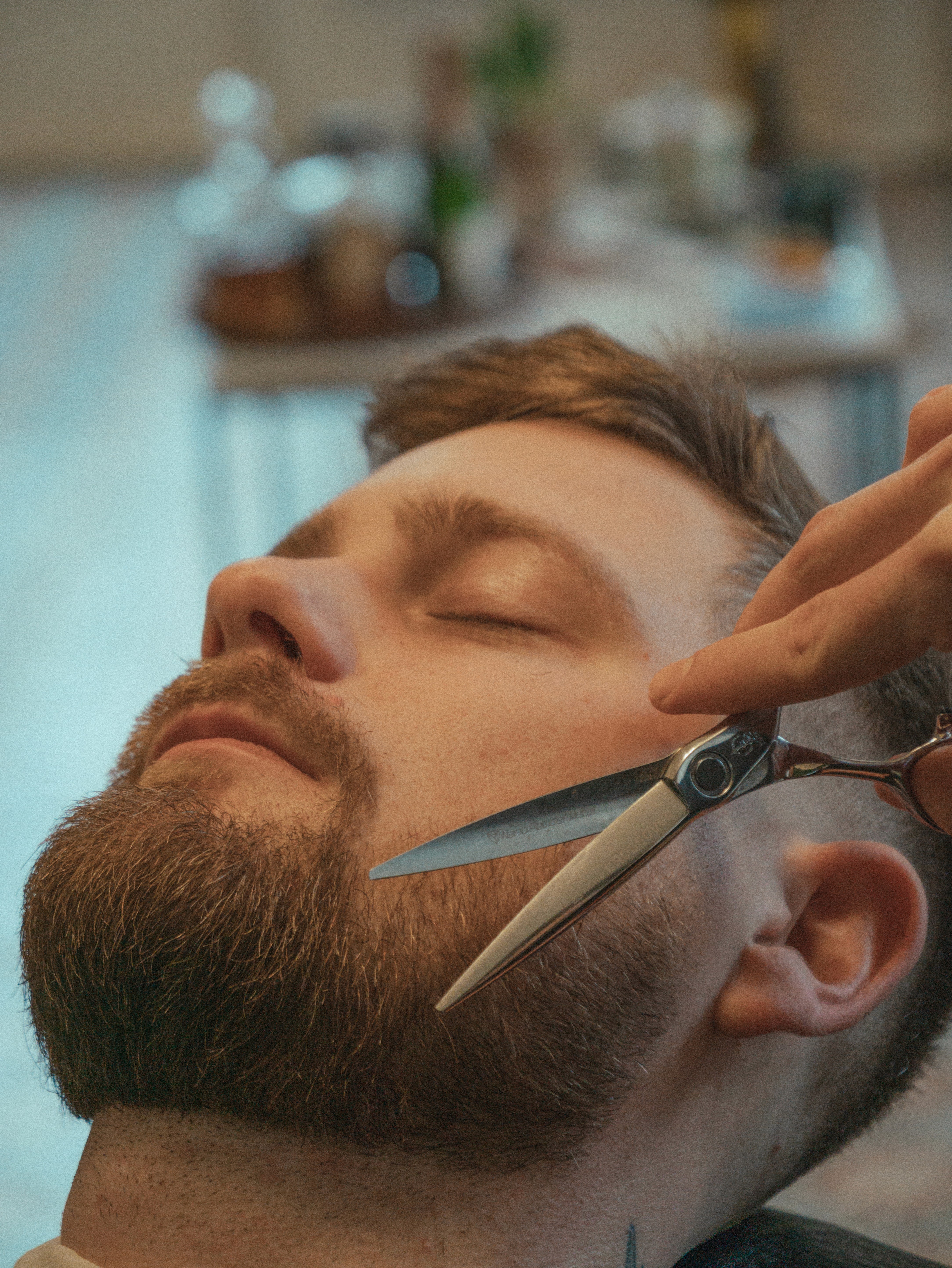 Beard being trimmed with electric clippers