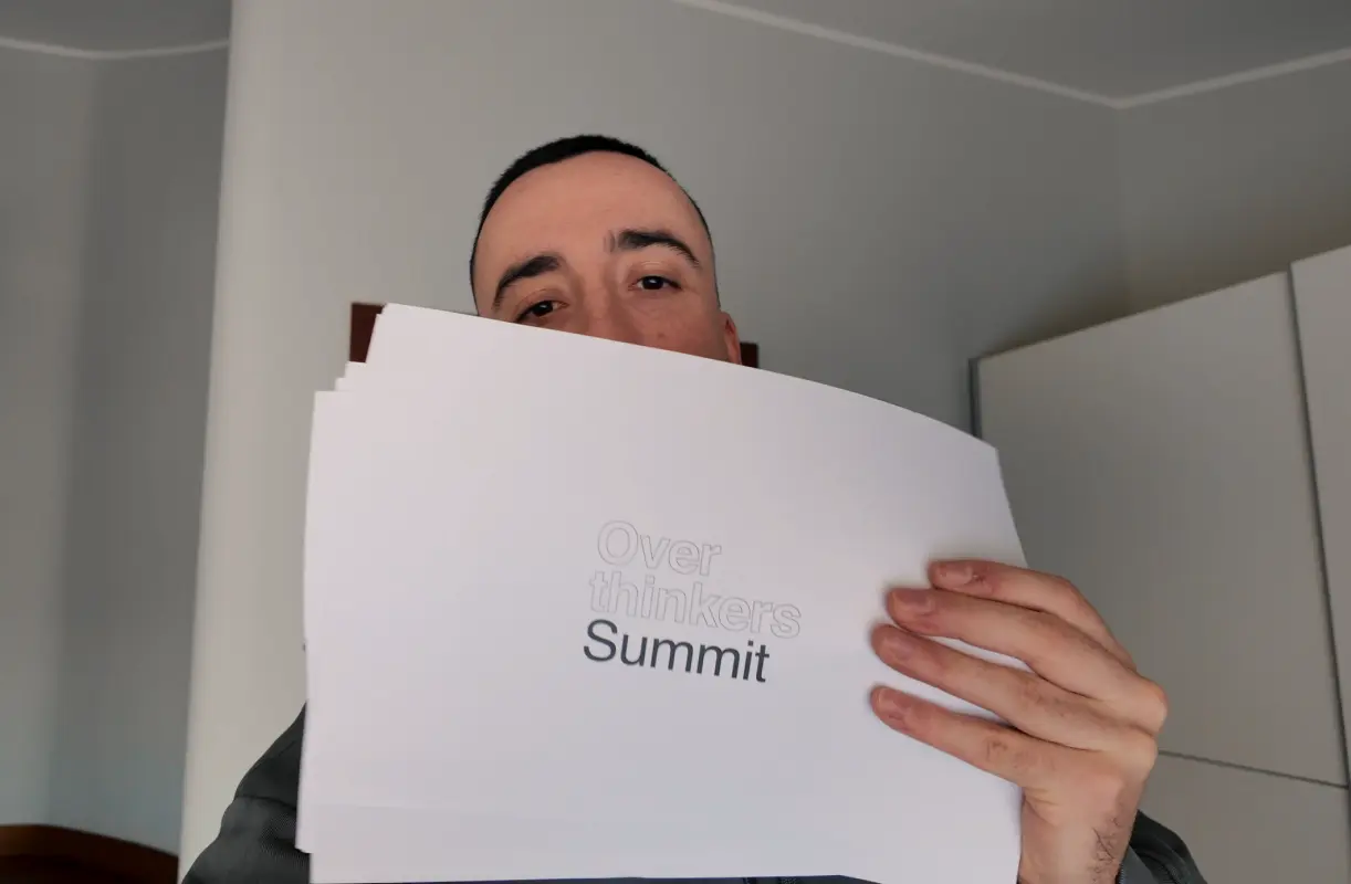 Ismael Branco reviewing printed work and materials