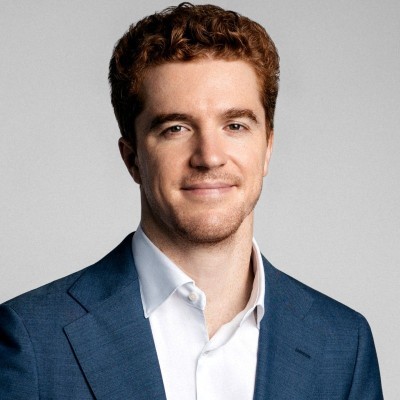 man in gray suit standing on gray concrete floor during daytime