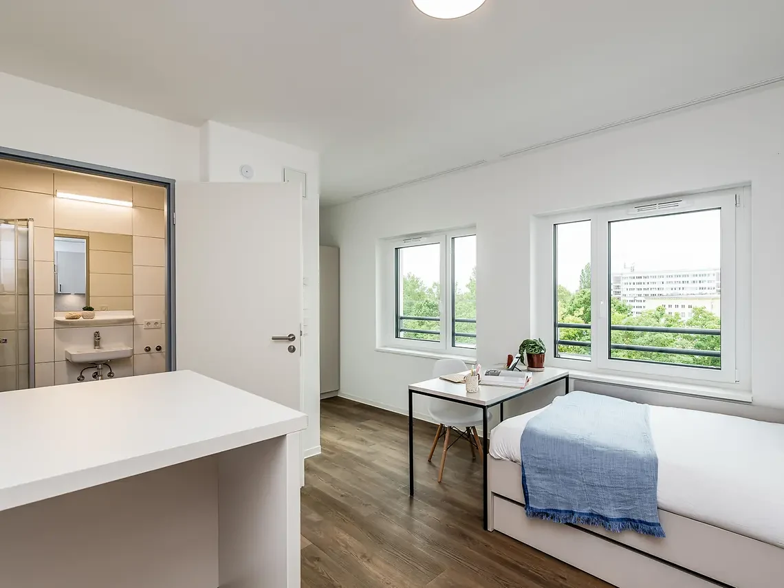 Private student studio in Berlin with bed, desk and bright study area