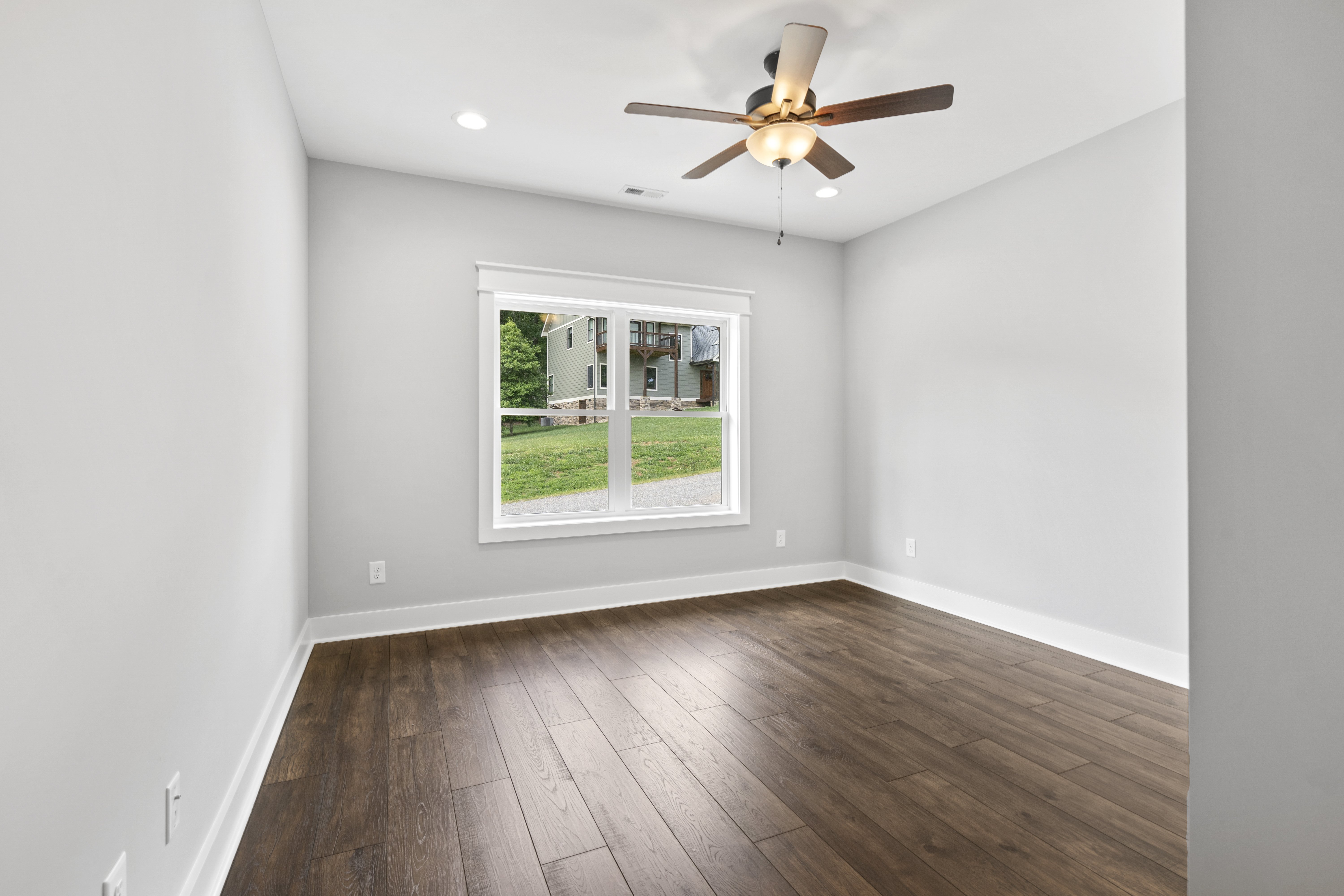Open concept kitchen and living room with vaulted ceilings and hardwood floors