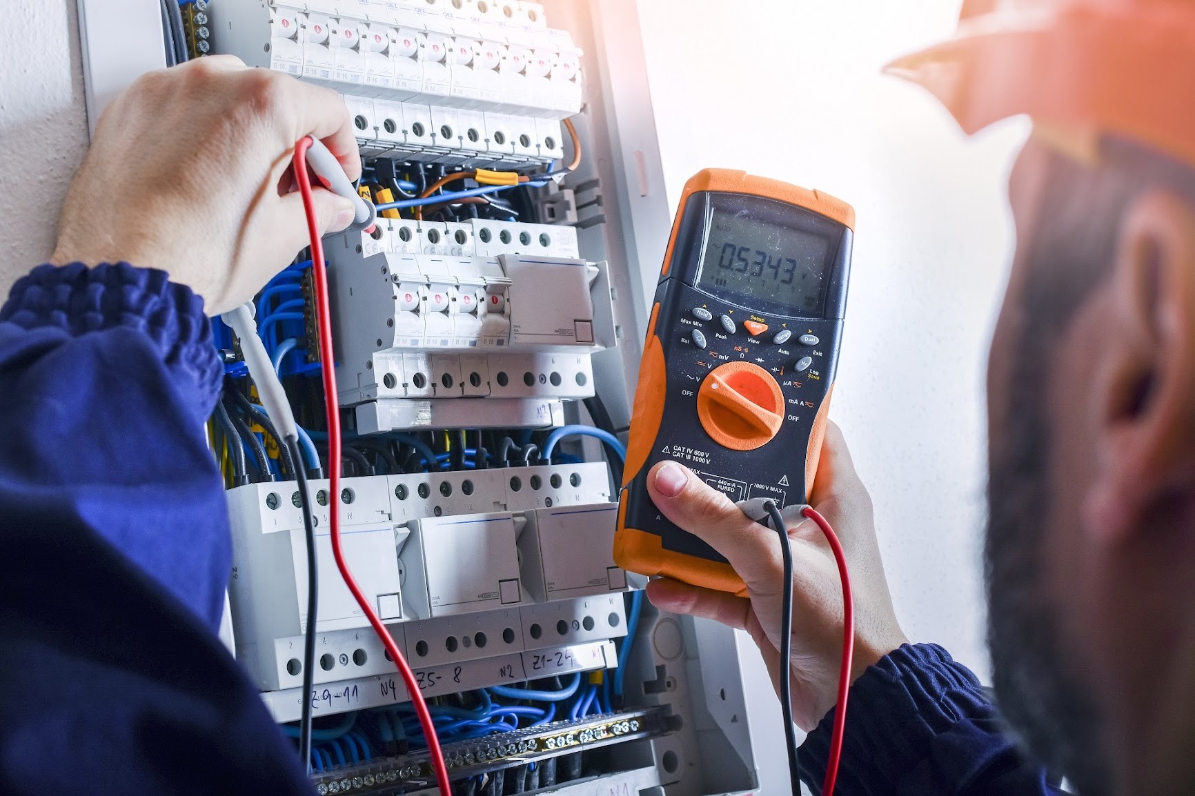 Electrician working on a troubleshooting service for a residential home