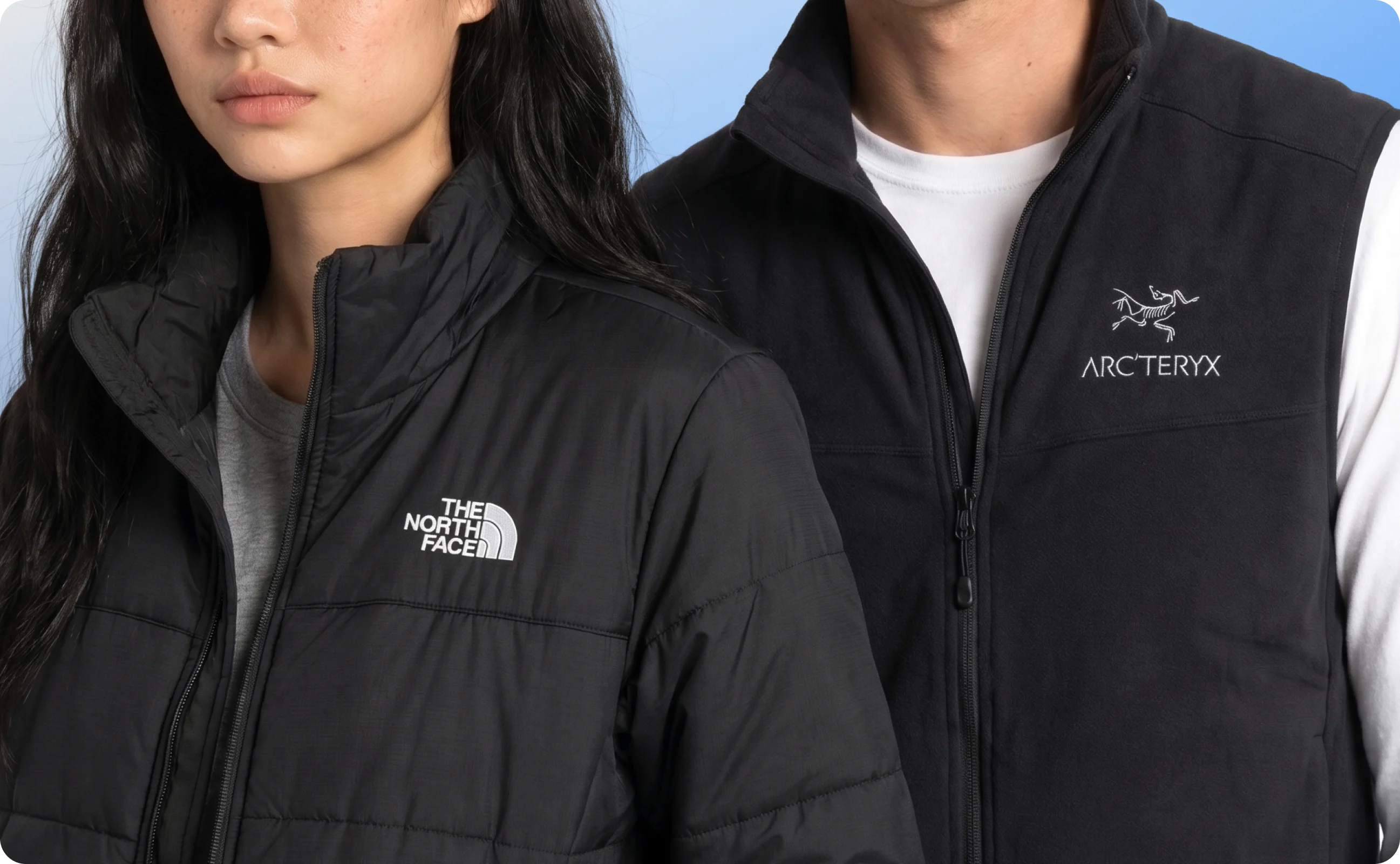A woman wearing The North Face jacket and a man wearing an Arc'teryx jacket.