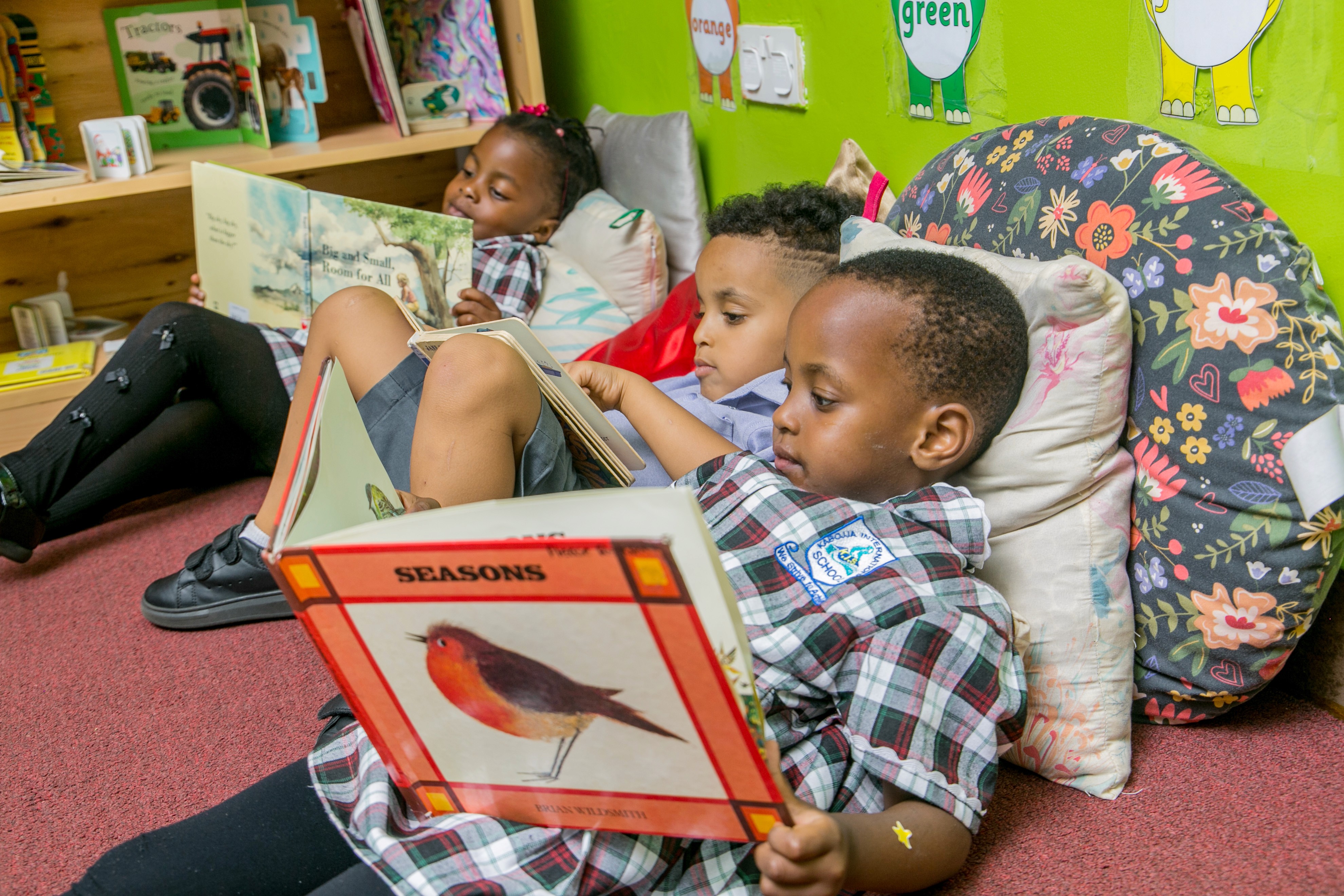 A mother and her son are sitting together, using a tablet to work on homework