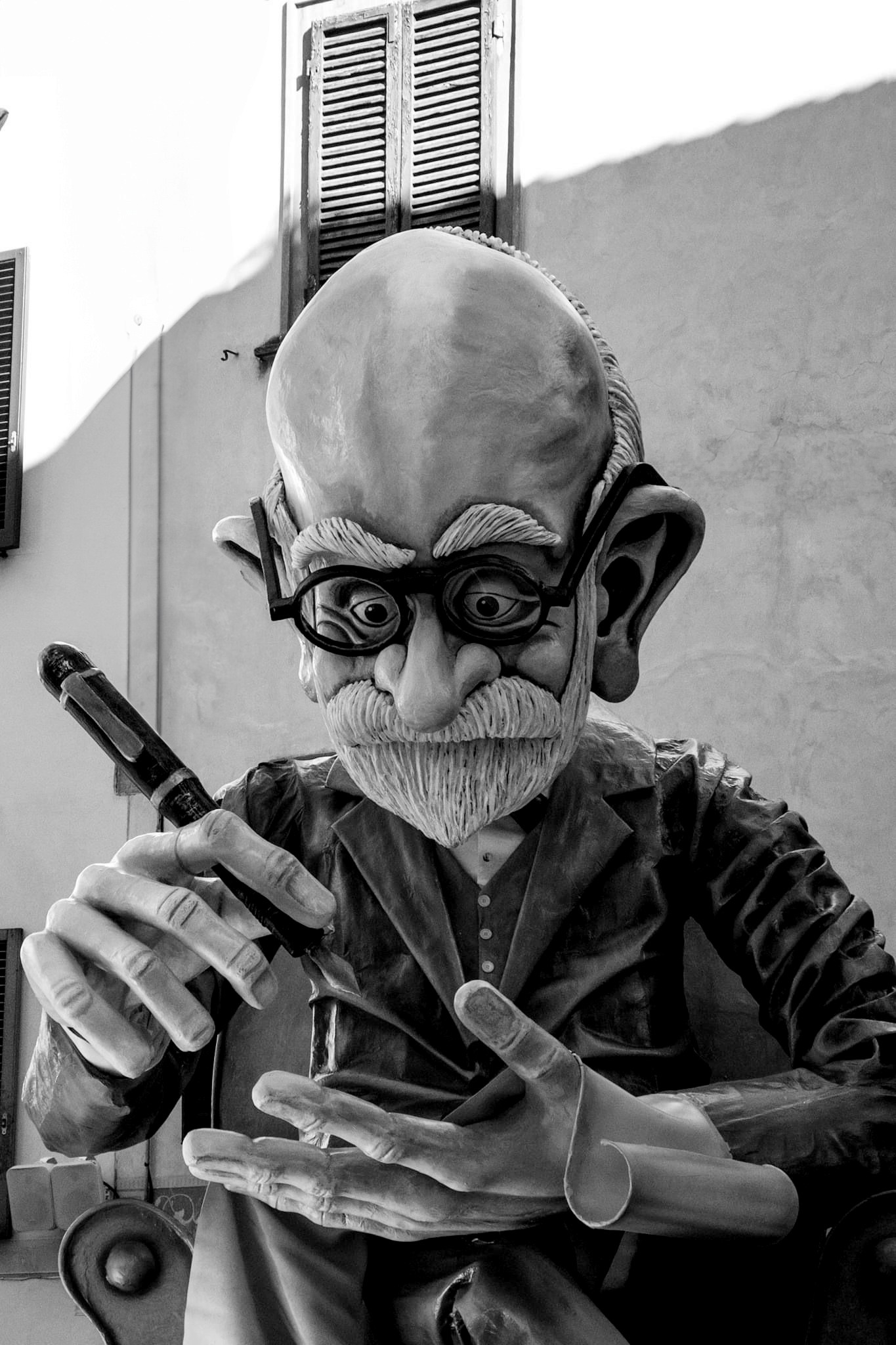 A woman in a straw hat stands in the grass