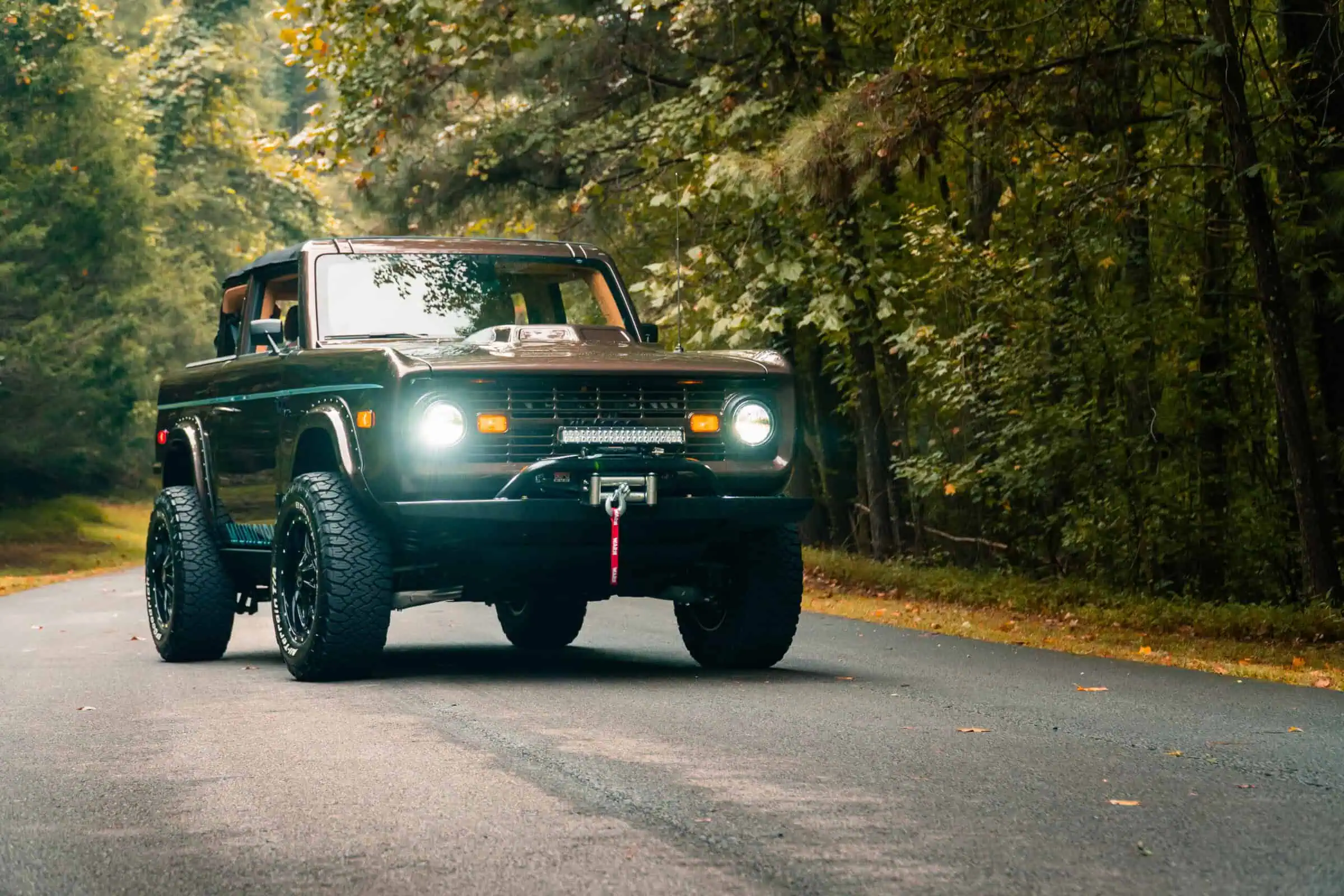 Man with camera near lake and mountains