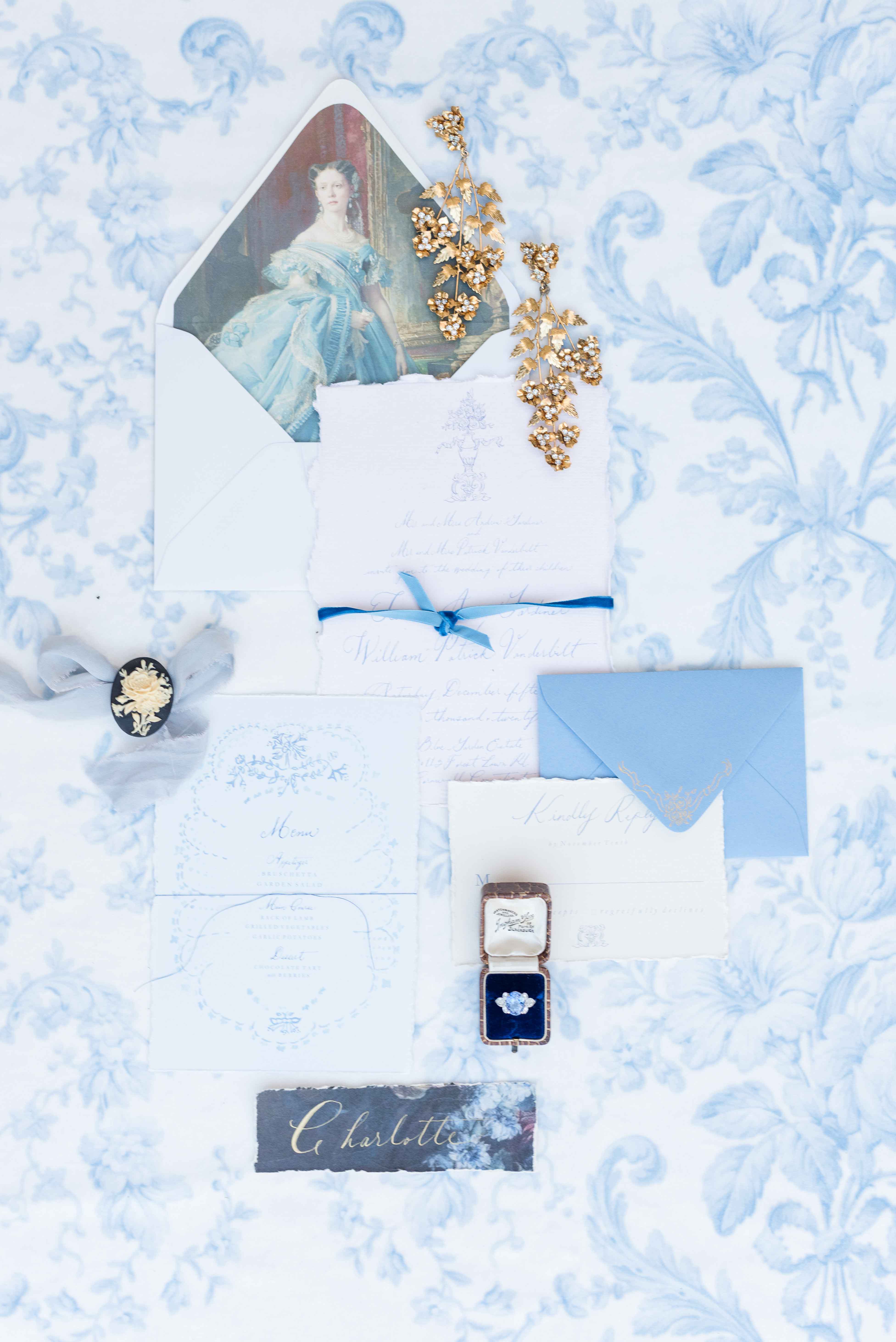 French flatlay of wedding invitation suite.