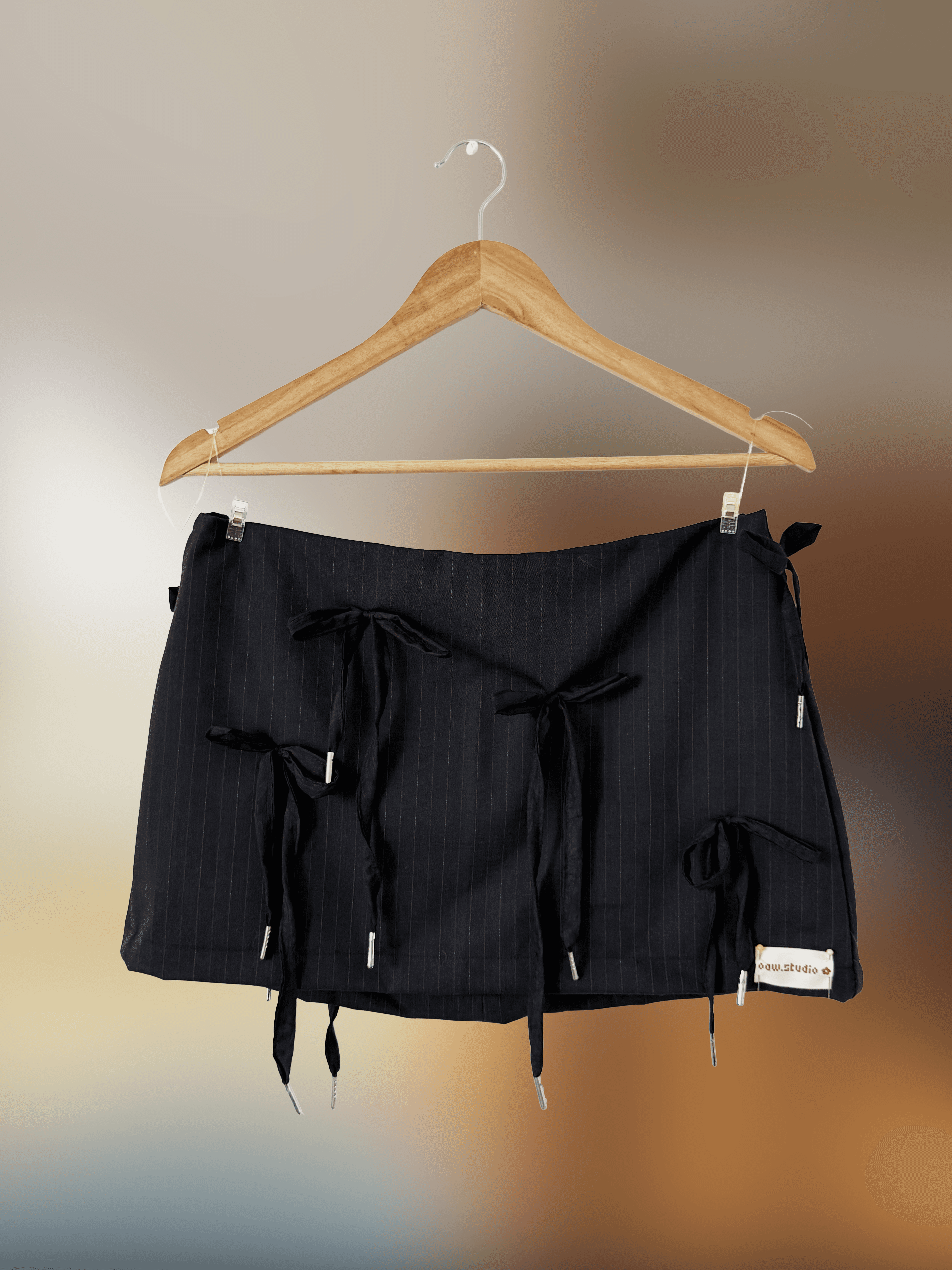 Mini black pinstripe skirt with tie detailing