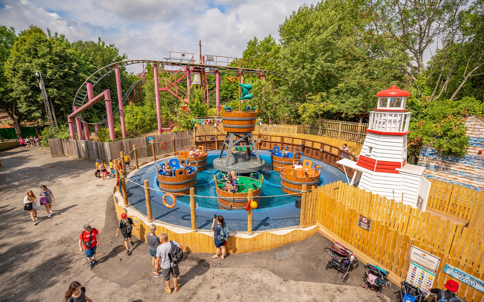 Chessington theme park main area with roller coaster and visitors exploring attractions.