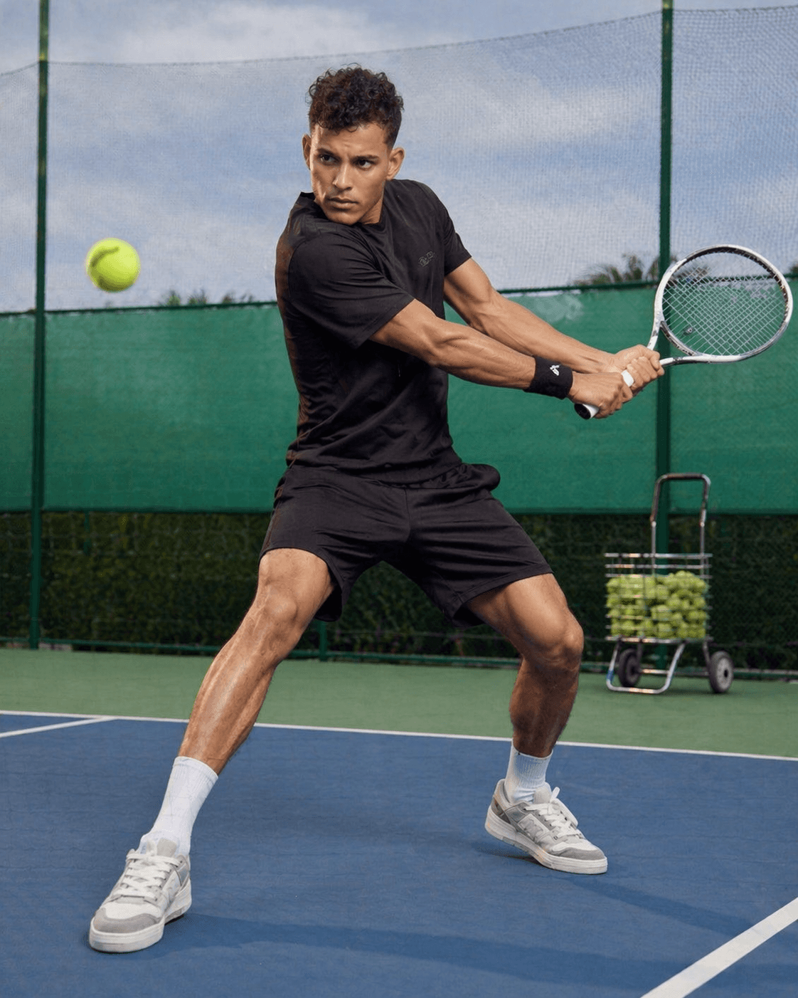 A male tennis player hitting the ball