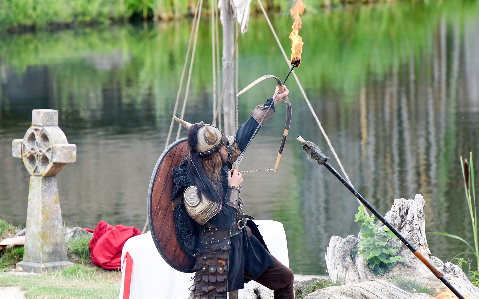 Viking reenactor with flaming arrow at Puy du Fou, France.