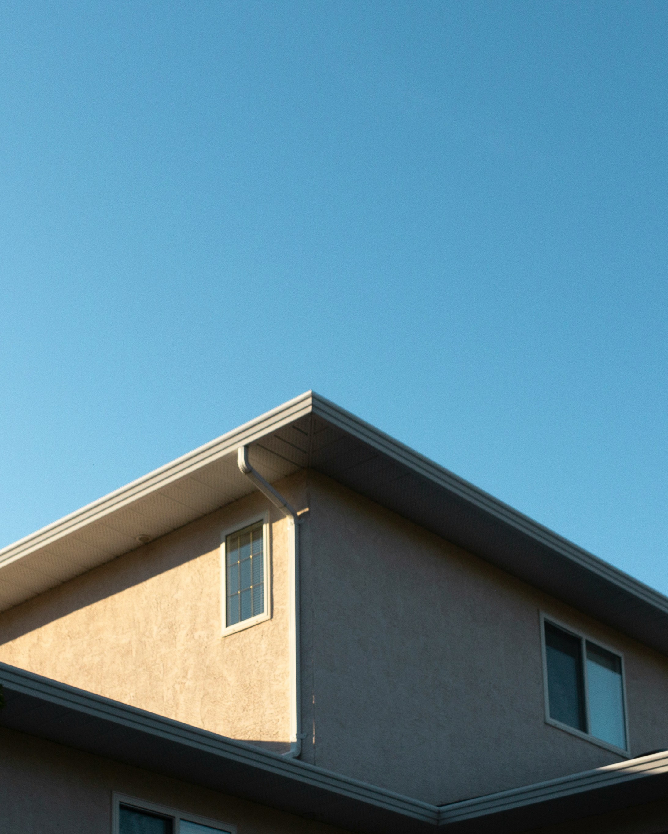 brown concrete house under blue sky during daytime