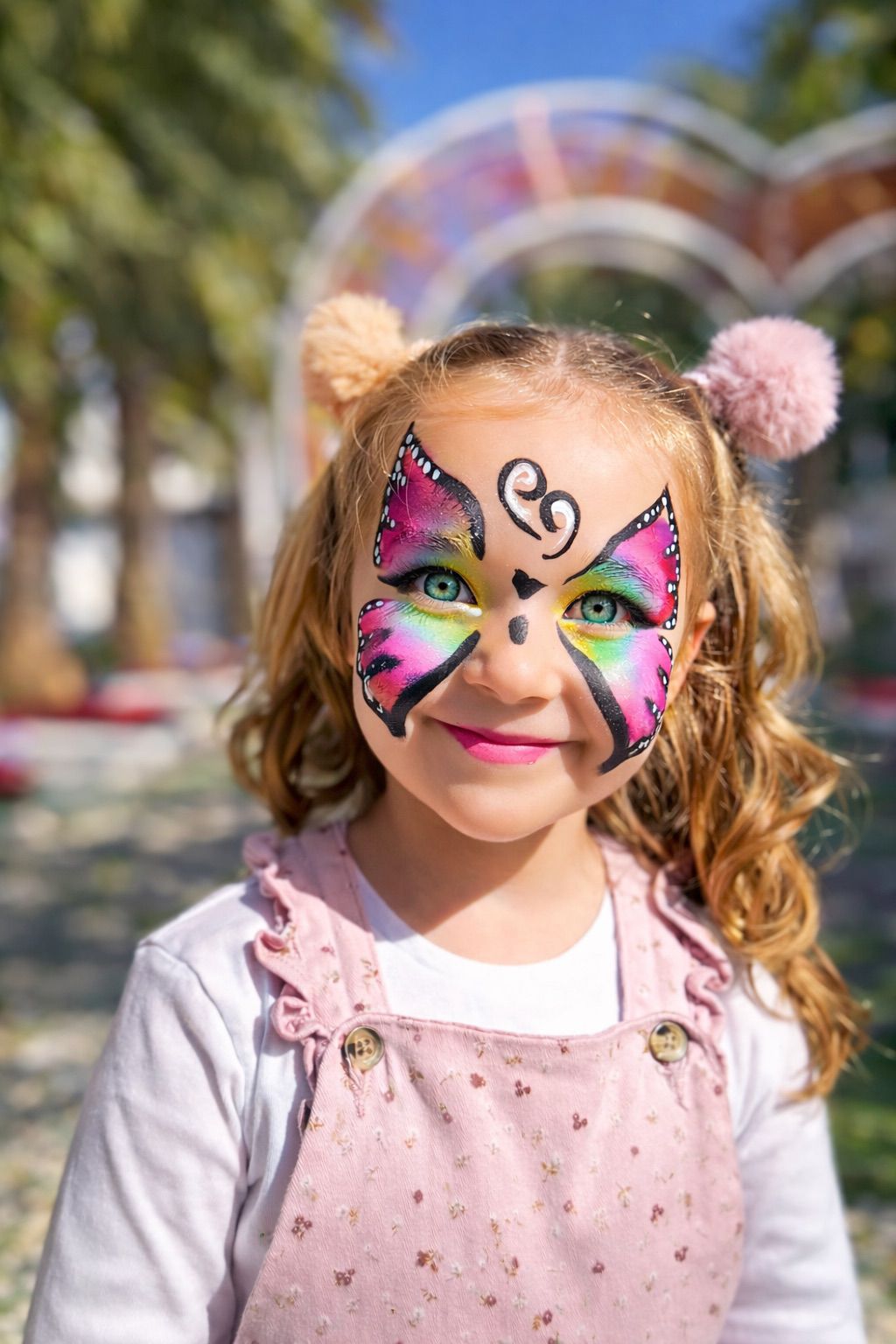Vibrant digital illustration of a cat with blue eyes, featuring splashes of multicolored paint in yellow, blue, and pink on a dark background, showcasing a creative and artistic style.