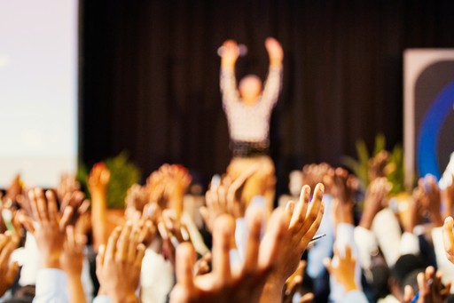 A quick exercise session during the conference where everyone has raised their hands