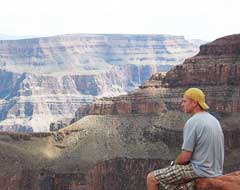 A photo of David sitting at the edge of a hill