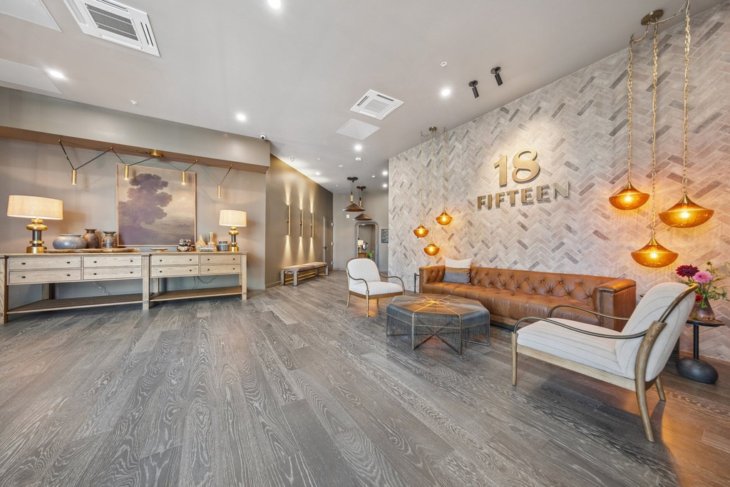 Lobby with 18 Fifteen signage on a herringbone stone wall
