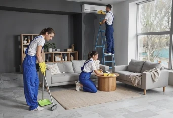 Three persons are cleaning the room.