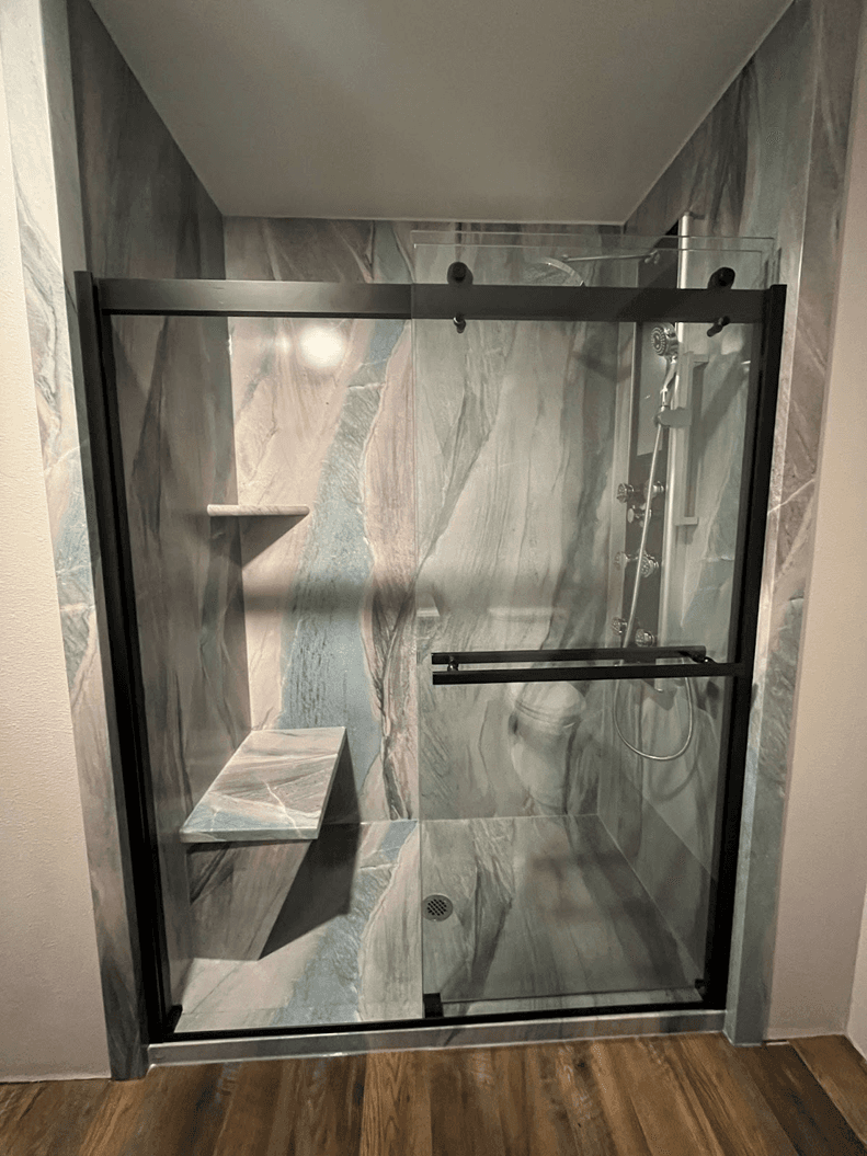 Walk in shower with modern shower spa and built in seating