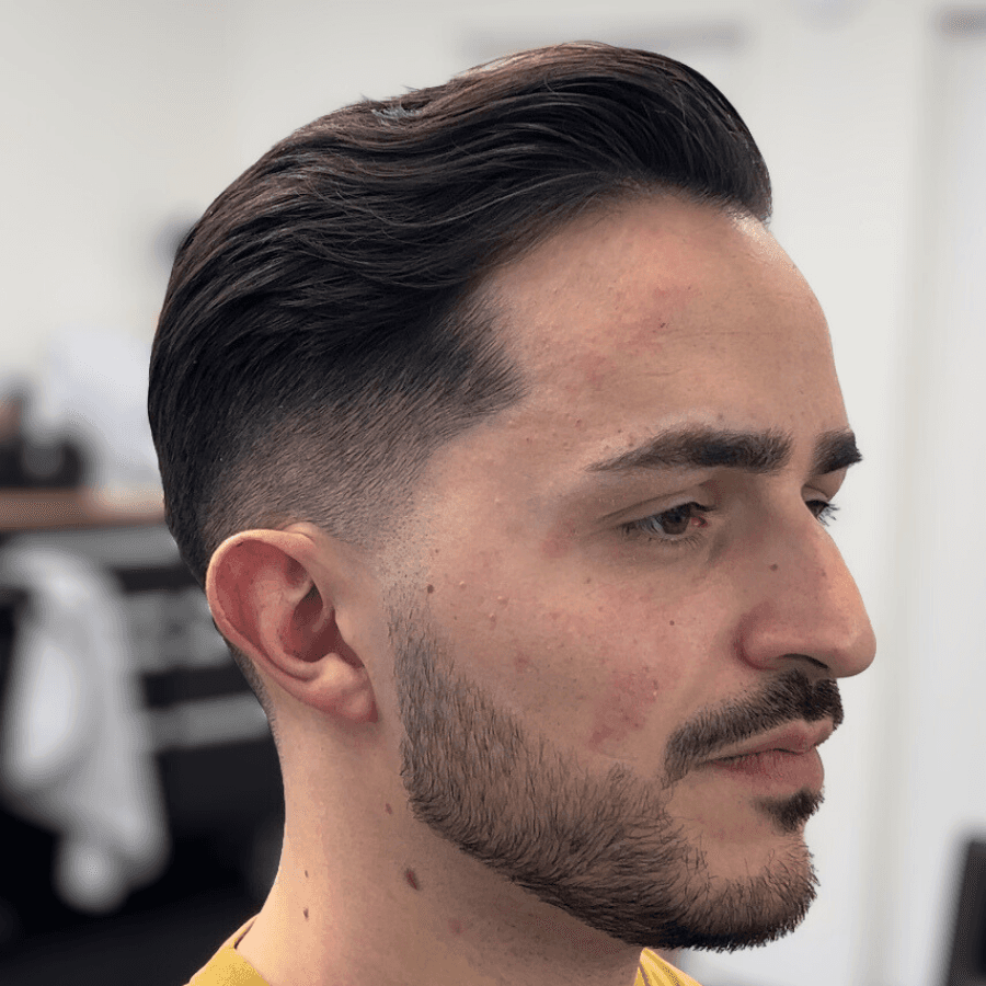 person holding white and gold hair comb